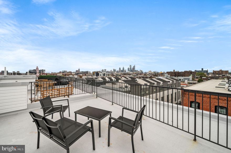 Discover luxury living in this stunning 2-bedroom, 2-bathroom home offering a beautifully finished open-concept floor plan, complete with private garage parking and garage door opener included for your convenience. Built in 2022, this sophisticated home still has over 6 years of tax abatement remaining and features soaring 12-foot ceilings, elegant wood-grain floors, and a private rooftop deck with panoramic city views - perfect for relaxing or entertaining year-round. The gourmet eat-in kitchen is a chef’s dream with upgraded soft-close cabinetry, designer backsplash, gleaming quartz countertops, a breakfast bar for additional dining, and stainless steel appliances, including a double-door fridge, gas range, built-in microwave, and dishwasher. The kitchen opens to a spacious dining area and sun-filled grand living room, with oversized windows that flood the space with natural light. The second level offers a comfortable bedroom with three closets, a full bathroom with a tub/shower combo, and a large laundry area featuring side-by-side front-loading machines. The third floor is your private retreat. The primary suite includes a large walk-in closet, a linen closet, private balcony, and a luxurious bath with double vanity, spa-inspired walk-in shower, and beautiful tile finishes. From the primary suite, head up to your expansive rooftop deck - a spectacular space for lounging, dining, and enjoying city views from sunrise to sunset. This luxurious new construction townhome is in the South Liberty Triangle community in the heart of Northern Liberties within walking distance to the shopping and restaurants on North Second Street, the ACME grocery store, Fine Wine & Spirits, Petco, as well as the luscious green park at Liberty Lands. Just a short walk to view the Delaware River. This location is fantastic! Come and take a tour!