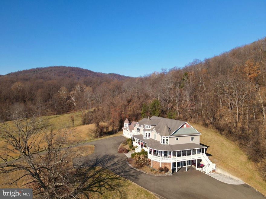 A 29 ACRE ESTATE with PANORAMIC Blue Ridge Mountains view, strategically placed between Washington and Sperryville VA.  Ideal for multi-generational or family compound without the care of extra buildings, though it does include a world class frisbee golf course!  ...  The home is large in size at 13,000 square feet, yet calmly livable and comfortable.  A Center Hall separates the formal Dining Room and Office, opening to a gracious Living Room with fireplace seating.     A Music/TV  room extends right and caters to additional entertaining,  just off the  Chef’s Kitchen with its own casual dining and mountain views.      Left of the Living room is a Library leading to a spacious Family Room with fireplace to spark warm conversations on holidays.  ...      Downstairs  walkout level offers bar, baths and double French doors to accommodate a future pool.   The adjoining room offers pool table and Big Game watching with kitchen/bar without cheers and shouts overtaking the entire house.  ...  Heading up the front staircase (there is also a back stair down to the kitchen) find 4 bedrooms & ensuite baths.  The two large primary bedrooms offer alcoves facing the view.    An Apartment  with one bedroom is located off the Family Room and offers kitchen/living/dining room (OR) perfect bunkhouse space for youngsters with two full baths.  An efficiency apartment is over the garage.      Options abound throughout this home and the view is spectacular.