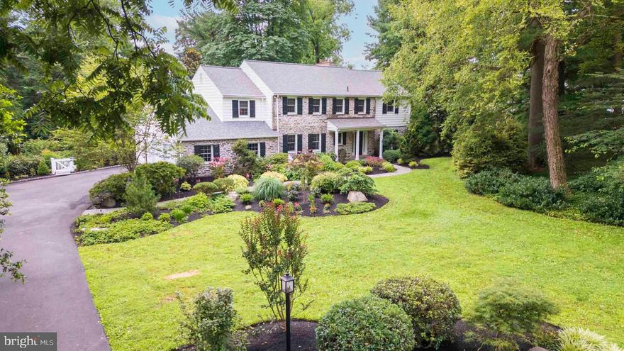 Tucked away in a coveted enclave within the Award-Winning Abington School District, this exceptional 5-bedroom, 3.5-bath stone colonial blends timeless architecture with refined modern comforts and is situated on a large and beautifully landscaped 1 acre lot. Encompassing over 3,600 square feet of thoughtfully designed living space, this residence is a testament to quality craftsmanship, elegant updates, and sophisticated functionality.  A gracious foyer sets the tone for the home’s classic appeal, leading to a sun-filled formal living room with a marble gas fireplace and charming built-in window seat. The formal dining room offers the perfect backdrop for elegant entertaining, while the cozy family room and inviting breakfast room—with its gas brick fireplace and French door to a private flagstone patio—create a sense of relaxed luxury.  The chef's kitchen is a true showpiece, outfitted with radiant-heated tile floors, a large center island that comfortably seats four, Bosch dishwasher, microwave and conventional/convection oven, GE Profile induction cooktop, Dacor warming drawer, built-in Kitchen/Aid refrigerator, and deep double sink. Every detail has been curated for both beauty and utility. The kitchen, breakfast room and family room are all open to each other, and each space is defined by a low wall and columns.  Beyond the kitchen lies a custom mudroom with coat closet, custom built-in cabinetry, a first-floor laundry room, and a private home office with flagstone floors (radiant heat), custom built-in desk and window seat with built-in filing drawers- perfect for today’s work-from-home lifestyle. Wrap around windows and terrace doors in the family room and office create a strong interior/exterior link, with new raised terraces and landscaping adjacent to the house.   Upstairs, the luxurious primary suite is a tranquil retreat, featuring four generous lighted closets (including a cedar-lined one) and a spa-inspired en-suite bath with radiant heated floors, dual vanities, and a custom-tiled shower. The 2nd and 3rd bedrooms are joined by a Jack & Jill bath, while the 4th and 5th bedrooms are served by a beautifully updated hall bath with dual sinks and tub/shower unit.  A hall linen closet and pulldown stairs to attic storage complete this floor.   The finished lower level expands your living space with a large sitting area, 4 closets and dedicated fitness space.  There is a separate workshop, utility room with NEW gas boiler, and an outside exit with Bilko door. A 2-car attached garage with 220V EV charging receptacle, attic storage,  Generac whole house generator, new roof (2021), new A/C units (lower-2023; upper-2024) complete the home’s impressive offerings.  Situated near Whole Foods, Trader Joe’s, Abington-Jefferson Hospital, Penn State-Abington, upscale shopping, fine dining, and several regional rail stations, this home provides unparalleled access to everything you need, while offering the privacy and serenity of a beautifully landscaped setting with a tranquil waterfall feature in the back yard.  This is not just a home, it is a lifestyle.