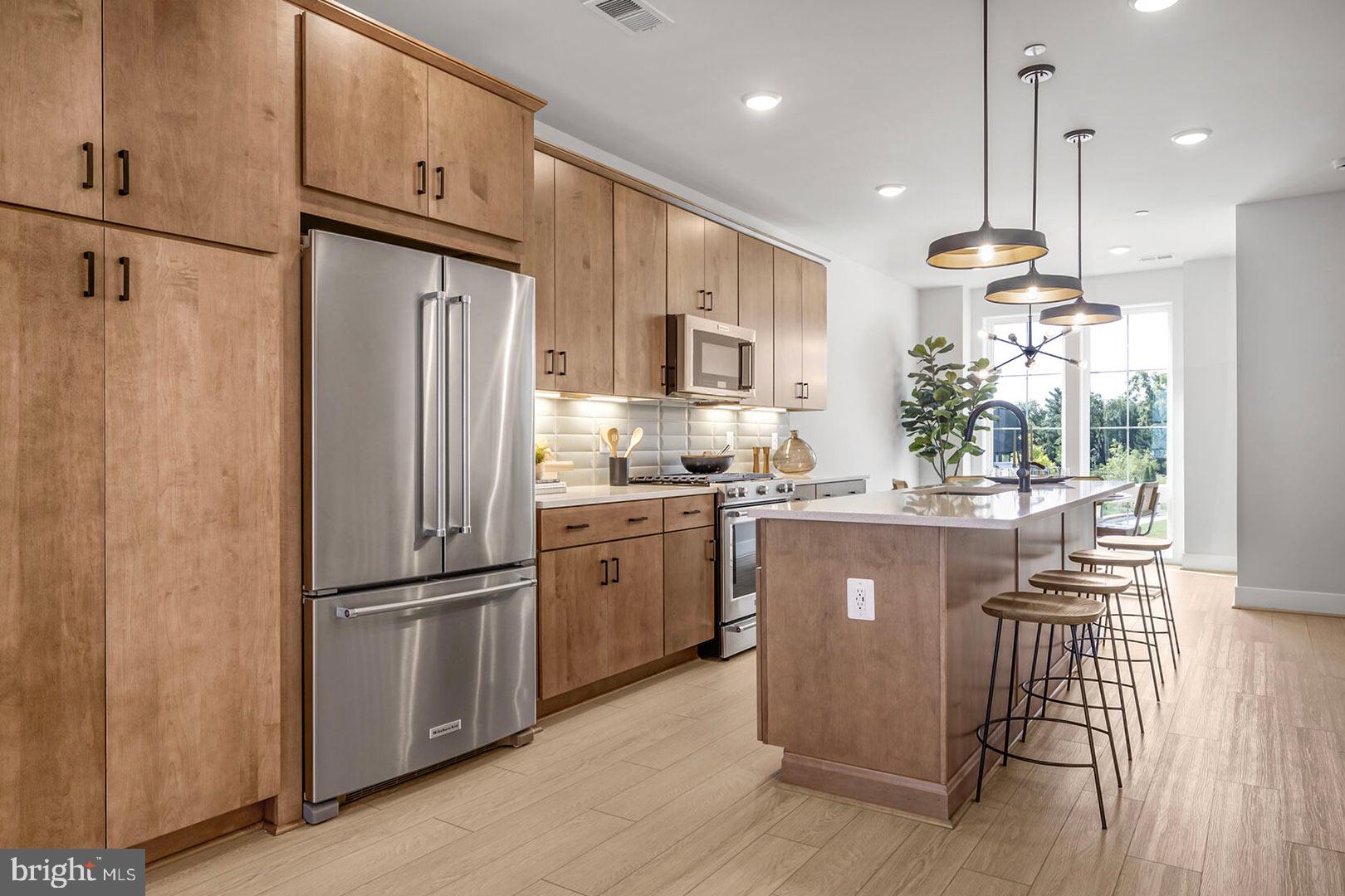Step inside the open and airy main living level where you will find a Chef’s dream kitchen that opens to the outdoor living, a spacious dining room, and a large great room with electric fireplace and built-ins. The kitchen is complete with Calacatta Gold quartz countertops, Gunny cabinets, KitchenAid appliances, and warm brass finishes. Upstairs boasts a luxe primary suite with huge walk-in closet, plus an additional bedroom with its own private bath. The third level offers a light-filled loft with beverage center, an additional bedroom and full bath, and access to the rooftop terrace. The level is complete with a flex room and an additional full bath. Photos shown are of the Bryce model.