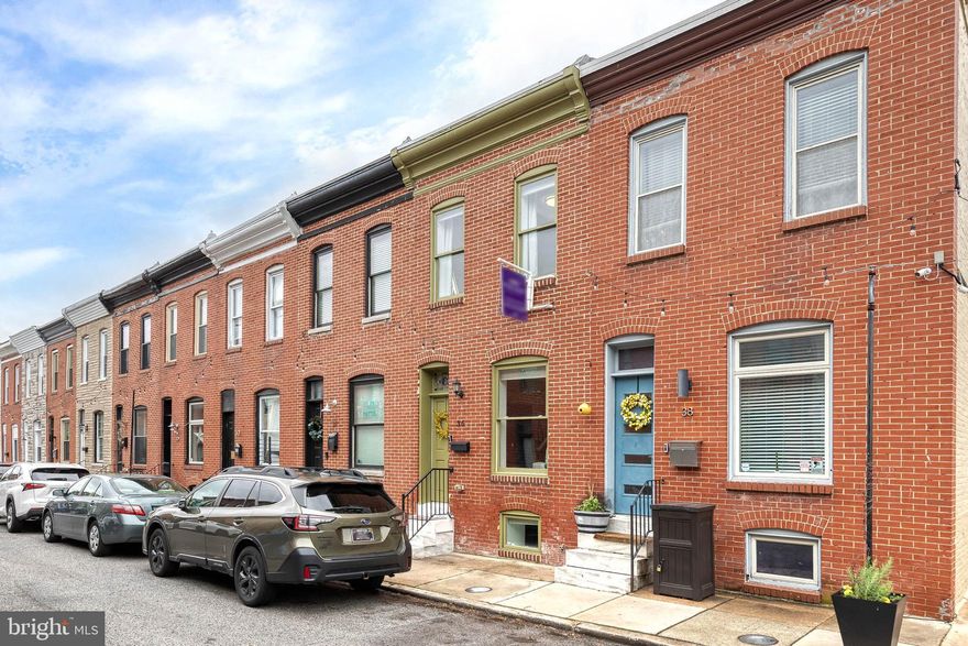 Beautiful 3-story brick rowhome in the heart of Patterson Park featuring 3 bedrooms, 2 full bathrooms, and 1-car parking. This home offers hardwood flooring and recessed lighting throughout, with a bright, open main level combining living, dining, and kitchen spaces. A stylish light-edged accent wall adds character between the living and kitchen areas.

The kitchen is equipped with stainless steel appliances, dark cabinetry, an island with seating, and an exposed brick accent wall for added charm. Upstairs, you’ll find two spacious bedrooms with hardwood flooring and exposed brick, along with an updated full bath featuring a tiled stall shower, separate soaking tub, and skylight.

The fully finished lower level includes a third bedroom, second full bathroom with tiled shower, and a convenient laundry closet with stacked units. Enjoy the rear enclosed concrete patio with wood fencing, ideal for outdoor relaxation, plus the bonus of a private 1-car parking pad. Welcome home!