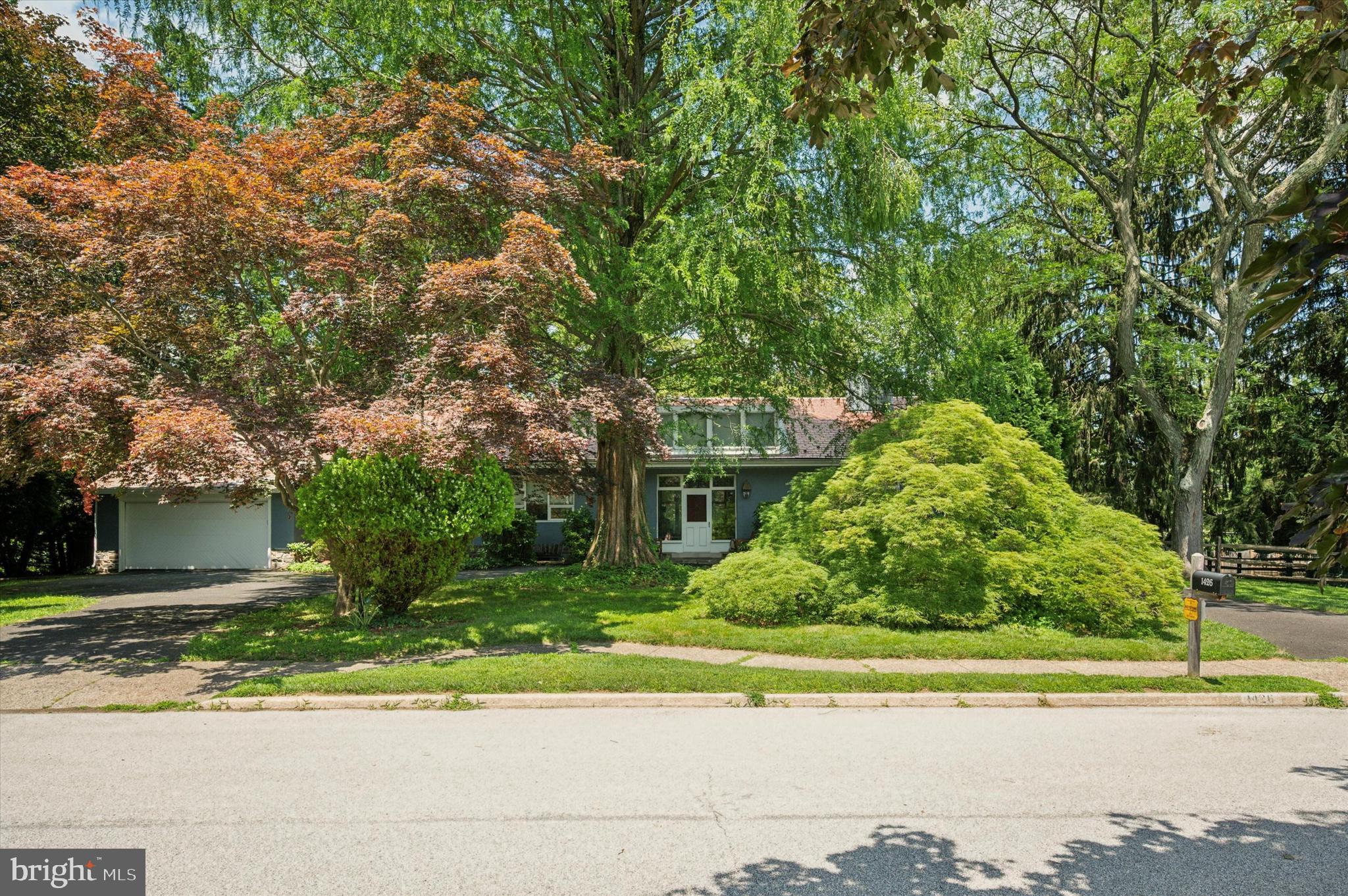 Welcome to a timeless Meadowbrook gem on the market for the first time in 52 years. Known as the “Manor” House and built in 1890, this home blends historic elegance and craftmanship with modern-comfort appeal and charm. This magnificent one-story home enjoys 10-foot ceilings in all rooms; a sun-filled living room with a vaulted ceiling and over-sized transom windows; original wood molding and built-in bookcases; a round dining room featuring two window seats, and three, large built-in cabinets for storage; four inviting wood-burning fireplaces; a spectacular, wrap-around, totally private, Pennsylvania fieldstone porch that runs along the entire back of the house and is shaded by majestic cedar trees; and, a beautifully landscaped yard with rare and mature trees, gardens and shrubbery. This house was built for indoor-outdoor living and
entertaining. Nestled on a fully-fenced-in, private 0.7-acre lot, this spacious home offers three bedrooms, 2.5 baths, a generous 3,562 square feet of living space and a beautifully designed, finished basement. A half-circle driveway leads to a gracious foyer and antique, hardwood floors, setting the tone for the warmth and charm throughout. The bright, open living room features built-in bookcases, doors to the outside wrap-around stone porch, and a fireplace, offering cozy winter nights and cool, shaded summer afternoons and evenings. The living room flows into the very spacious, round dining room which easily accommodates a 9-foot dining table, with ample room for a buffet and a side-table for holiday get-togethers. The dining room then flows seamlessly into the large family room, with built-in bookcases and dual exit doors to the
expansive back porch and backyard. Wood-burning fireplaces are featured in all three rooms. The bright kitchen features large windows with a southern view of the front yard, a gas range, room for a table and four chairs, ample cabinet space, three closets, with an additional door to a fenced-in side yard ideal for a dog run. Three well-appointed bedrooms are located in a private wing, which includes a generous primary suite with a
fourth fireplace, three closets, a wall of windows overlooking the backyard and gardens, and a small, attached room perfect for an office or study. Further, an expansive attic offers the opportunity to create additional living space or bedrooms, as the original structure stood three stories tall. In 1950, the Manor House was purchased by an architect who also planned and built the surrounding neighboring homes. The architect transformed the 1890 Manor House into this unique and spacious single-level home that exists today by preserving and blending the old with the new. When you head down to the basement, you discover a stunning party room and pool table (Brunswick Ventura with leather drop pockets included), with a wet bar, sitting room, and half bath; a spacious laundry room with a large, walk-in cedar closet and two other storage closets; and, an expansive, unfinished portion of the basement providing additional storage capability. A monitored security system offers peace of mind and is currently on a month-to-month agreement, requiring no obligation for the buyer. Blending uniqueness, character, and comfort, this Meadowbrook home is truly special and one of a kind. It is situated in an exceptionally friendly neighborhood with sidewalks for safe walking for ourselves, and our pets. Conveniently located near the Meadowbrook Septa train station makes it a breeze to get into Center City and other points of interest. Rydal Elementary School (Abington School District) is only fiveminutes away. Schedule your showing today!