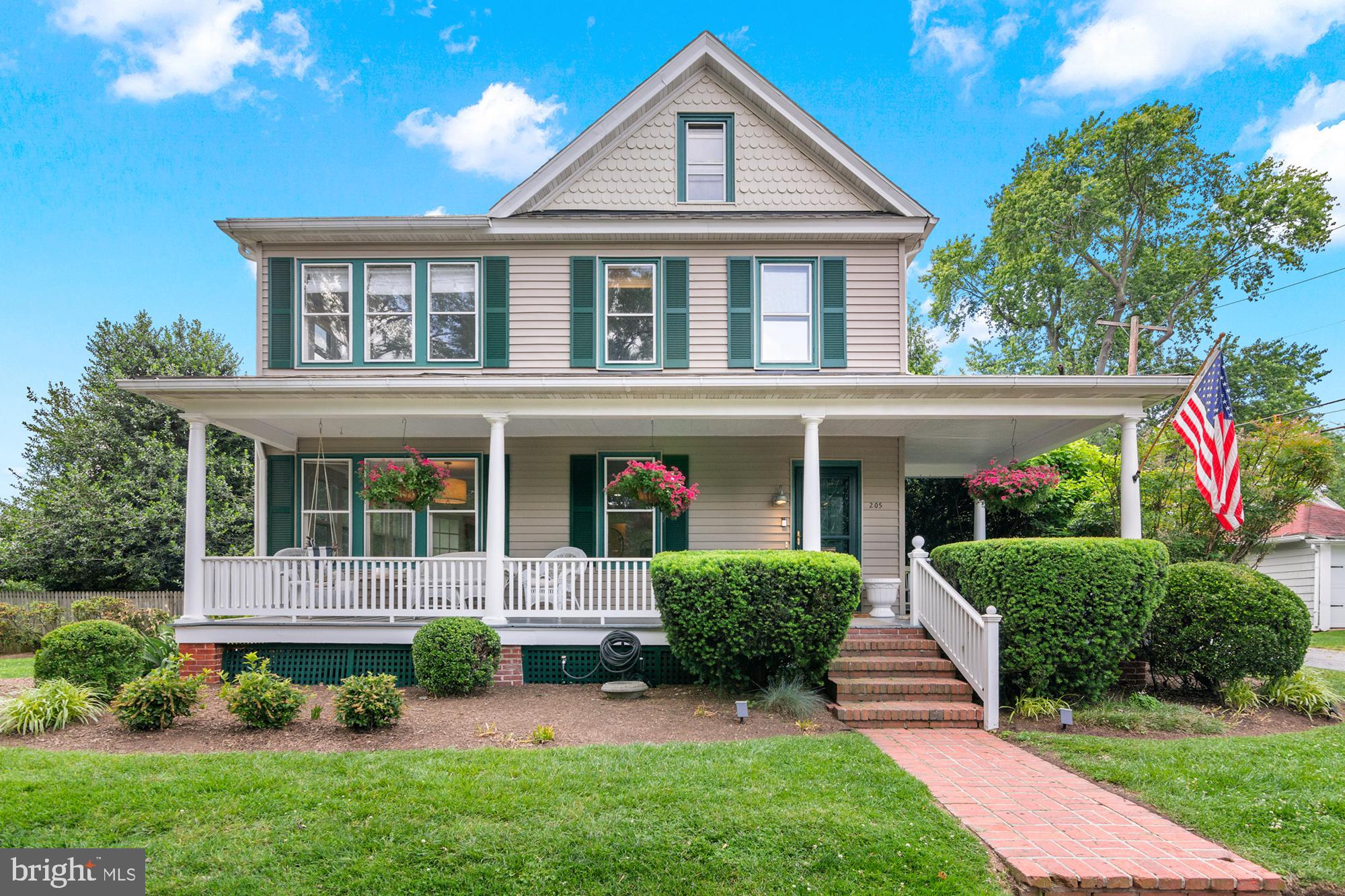 Nestled in the heart of Easton’s Historic District, 205 S Hanson Street is a beautifully preserved early-20th-century home that exudes timeless charm and sophistication. Built around 1910, this elegant Colonial Revival offers approximately 2,520 square feet of refined living space with original hardwood floors, detailed millwork, and gracious proportions that reflect its rich architectural heritage. Set on a rare double lot of roughly 0.41 acres, the property provides an exceptional sense of space and privacy. The expansive backyard is a true sanctuary, featuring a sparkling in-ground pool surrounded by mature landscaping, including shade-giving trees, colorful garden beds, and manicured hedges. This lush outdoor setting offers the perfect backdrop for entertaining, quiet afternoons by the pool, or al fresco dining under the canopy of established magnolias. Inside, the home offers a warm and inviting layout. A central hallway opens to formal living and dining rooms, a cozy family room, and a thoughtfully updated kitchen that blends modern amenities with historic character. The upstairs features a spacious primary suite with an en-suite bath, along with three additional bedrooms and a shared hall bath—ideal for family living, guests, or a home office setup. Located just a few blocks from Easton’s vibrant downtown, this residence offers walkable access to shops, restaurants, art galleries, and cultural attractions, all while providing a peaceful retreat on one of the town’s most charming streets. With its rare double lot, resort-style pool, and meticulously landscaped grounds, 205 S Hanson Street is a one-of-a-kind property that combines historic elegance with everyday comfort and convenience.