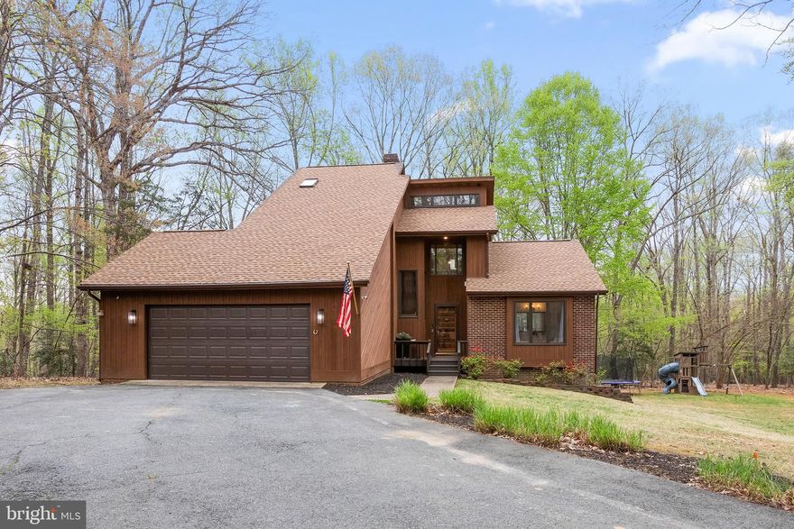 Stunning Home, " The Cowboy on River Road" as the owner's like to affectionally call it! Nestled down a long and winding fully paved driveway, for a stunning entrance!  Peaceful and Serene wooded 3 plus acre lot in desirable River Bluffs, this custom home with over 3500 sq feet offers Beauty, Tranquility and Privacy.  Location, Location, Location.... Conveniently located to be able to travel to Central Park, Downtown, and 95 yet is a world away from all the hustle and bustle. Boasting 4 spacious bedrooms and 3 large full bathrooms, cathedral ceilings and expansive windows for natural light to fill the home.  The Spacious Primary Bedroom and Full Bath are located on the Main Floor.  The Main Floor flows boasting walls of windows looking out into the trees and back yard.  The Main Floor entails a Great Room boasting a  Wood Burning Brick Fireplace that extends to the ceiling, Spacious Dining Room that fits a table for 12, and a Private Kitchen with top of the line beautiful white cabinetry with gorgeous granite and stainless appliances. The third floor is devoted to a private, amazing treehouse-like master suite with an entire wall of ceiling to floor windows that look out into the trees, including a spacious luxury master bathroom!  Two additional bedrooms on the walk-out basement level that share a family/rec room space, and a large full bathroom.  A large deck is located off the main floor reaching the entire width of the house for entertaining and enjoyment!  Jaw dropping views through the windows that hug this home!  Located on a cul de sac for safe play!  Home has been Extremely Well Maintained!
Electrical Panel is wired to a 65 amp plug for a generator to run the house, House comes with a 220 amp plug for electric car in the garage, Home has a buried 500gal propane tank that is owned ( not leased), Roof is 2 years old, Windows have been replaced, Cedar Siding was Freshly Painted as of last year, Entire Inside of Home has been painted with in the last year as well!