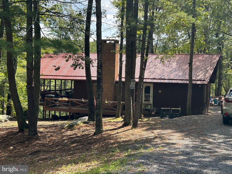 ADORABLE CHALET WITH OPEN FLOOR PLAN IN RITTERS HIDDEN VALLEY SD.  THE HOME HAS HAD MANY UPGRADES: NEW ELECTRIC PANEL, NEW MINI SPLIT (ALSO HAS A GAS WALL HEATER), NEW PELLET STOVE, NEW WINDOWS ON MAIN FLOOR, NEW PAINT, NEW FRONT DOOR & STORM DOOR, NEW KITCHEN CABINETS, NEW VINYL PLANK FLOORING, NEW RAILING, NEW METAL ROOF,  NEW TREX DECKING, NEW OUTSIDE OUTLETS, NEW SHED WITH ELECTRIC, NEW HOT WATER HEATER, NEW PRESSURE/HOLDING TANK, NEW WELL PUMP IN 2023 AND SEPTIC PUMPED IN 2023. THERE ARE 3 SHEDS ON THE PROPERTY, 2 WITH ELECTRIC. THE BACK OF PROPERTY CROSSES  OLD MILL ROAD AND RUNS TO THE CREEK, DILLONS RUN, FOR YOU TO ENJOY.  THE COMMUNITY OFFERS PLENTY OF RECREATIONAL ACTIVITIES; A BEACH AREA, SWIMMING, FISHING, TENNIS COURTS, PICNIC AREA/PAVILION, KIDS PLAYGROUND AREA, HUNTING/SHOOTING AND  RIDING ATV'S.  THE PROPERTY IS NOT UNDER AN HOA, BUT SUBJECT TO COVENANTS AND DUES FOR RITTER'S HIDDEN VALLEY ROAD & PARK MAINTENANCE. THE BUYER PAYS FEE AT SETTLEMENT FOR PREPARATION OF COMMUNITY DOCUMENTS.  YOU'VE GOT TO SEE THIS ONE!!!