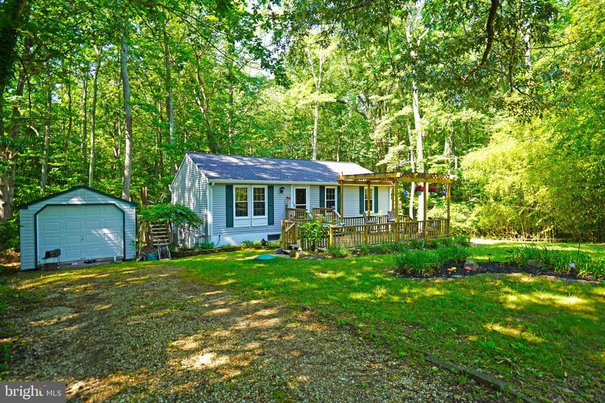 1.35 Acres of your own  privacy and seclusion  at the end of Robinson Ct.  Nestled in the trees and surrounded by nature yet still so convienent to everything.  Minuets to the many Pax River employment opportunities  as well as schools and shopping and other county ammenities.   Country kitchen opens to your deck overlooking  the lower backyard and woods beyond.  Fenced area for play or pets.  There is a full walkout basement that offers you room to expand your living area, a great workbench  for the handy person or an added workout room. Loads of storage as well. Enjoy your front porch deck and peacefull gardens too. Detached garage/shed will hold a car with room for additional storage.   Owner would like to leave the big screen TV setup in the living room as well as the work bench and cabinets in the basement and the home gym.