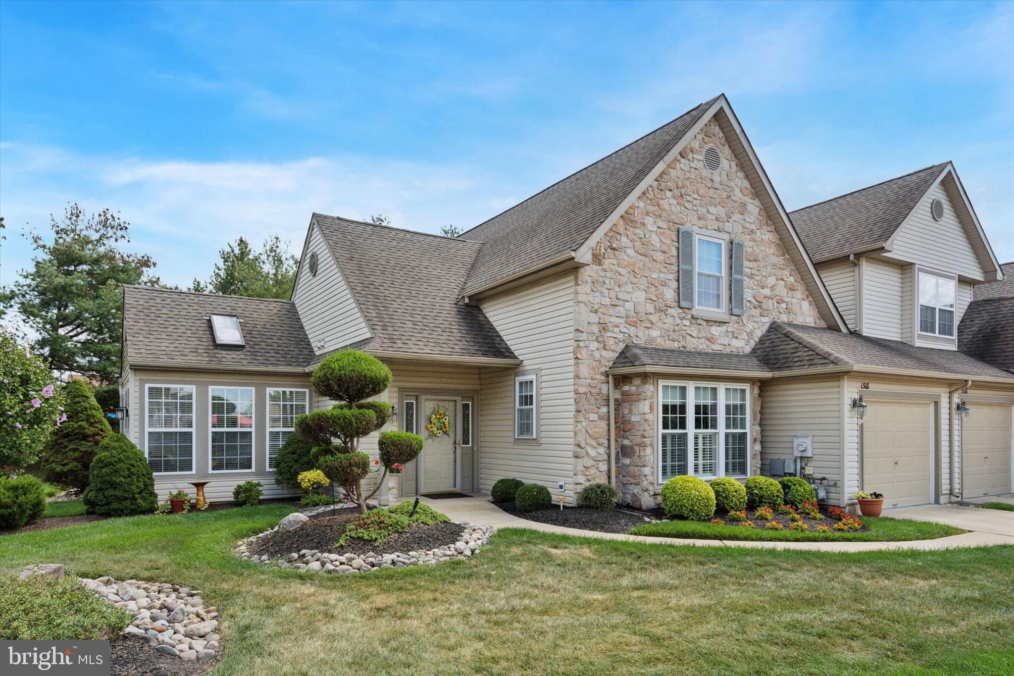 Tucked away on the back edge of Yorktown, a 55+ community in Jamison (Warwick Township), this end-unit townhome offers a maintenance-free lifestyle and a great location within central Bucks County. Built in 2000, this lovingly maintained home has approximately 2,300 SF of living space on two levels, 3 bedrooms, 3 full bathrooms, and a 1 car garage. From the driveway, a short walkway wraps around the left side of the home to a welcoming covered front entrance. Upon entering the home, you immediately notice the open floor plan with 9’ coffered ceilings, highlighted by beautiful marble surround gas fireplace with built-in shelving on either side. The combination living room/dining room has hardwood flooring throughout, with carpet inlays, creates the perfect space for entertaining friends and family on any occasion. From the living room, French double doors take you into the sunroom, a unique space not found in many other homes within the community. The sunroom is a comfortable space featuring vaulted ceilings, skylights, and three walls of windows bringing in lots of natural light throughout the day. The eat-in kitchen is adjacent to the dining room and is nothing short of functional. A white beadboard with chair rail and white cabinetry creates a classic appeal, while the new stainless appliances and tile backsplash provides a modern touch. The primary bedroom is on the main living level, is generously sized with a coffered ceiling, offering two walk-in closets, and a full bathroom. The master bathroom features a new double sink vanity and stall shower with glass doors, as well as direct access to a large laundry room. Another full bedroom, currently used as a den, and a full bath completes the main living level. The entrance door and closet in this room were removed to open the space but can easily be converted back to a private bedroom. Upstairs is the 3rd bedroom and 3rd full bathroom, as well as a large utility room for additional storage. For outdoor living, there is a paver patio surrounded by beautifully landscaped grounds, backing to a tree lined edge of the community. Other notable features of this home include public water and sewer, central A/C, natural gas forced air heat, and an alarm system. Amenities within the community include a clubhouse with fitness center, as well as an event space. This home is conveniently located within a short drive to the Borough of Doylestown, Lahaska, and Warrington, and has easy access in and out of the area via Routes 263, 313, 611 and 202.