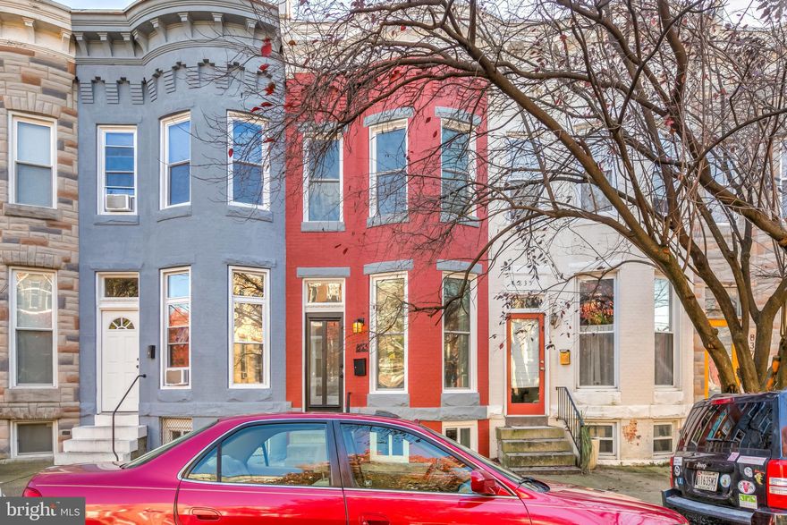 Here is the Hampden renovation you have been waiting for and it has off-street parking! Complete redesign of this bow front townhouse. Large open and airy space with massive windows and 8ft glass-paneled doors lets the light stream through this home. The main level has a large living room with a real coat closet, open staircase, dining area, half bath, and gourmet kitchen with white shaker cabinets and Quartz countertops. Off the kitchen is easy access to the spacious deck and parking pad The second floor has two-bedroom suites each with massive custom closets and luxurious bathrooms. The lower level has an additional room that can be a 3rd bedroom, family, or playroom, or home office along with a large bright white walk-out basement which is perfect to be used as a mudroom, craft studio, or laundry room. Central AC, Gas Heat, Instant Hot Water Heater. Steps to everything from this ideally situated location including shopping and dining options on The Avenue, The Rotunda, Moms Organic Market, Johns Hopkins University, Wyman Park, and Bike Trails.