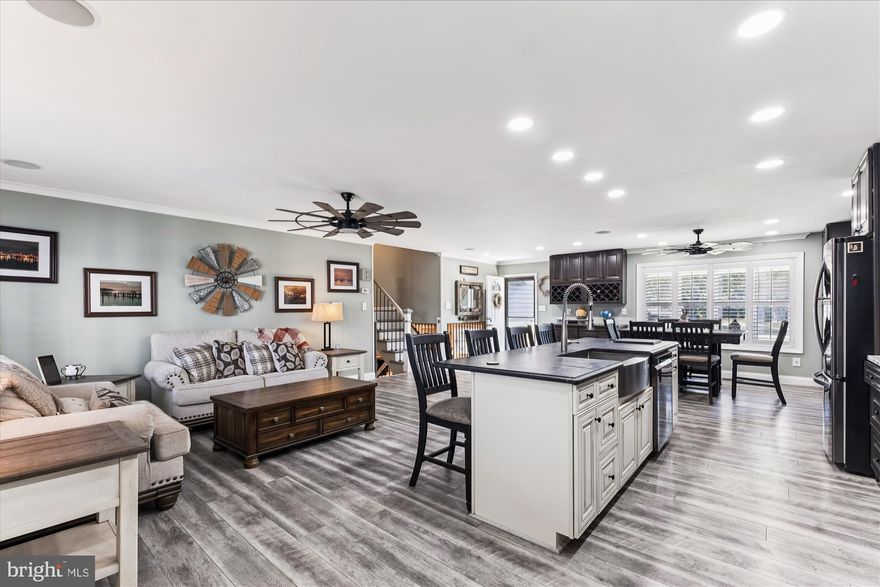 Seller to pay up to $30,000.00 in buyer settlement fees. Contact the listing agent for details. This beautifully renovated multi-level home features over 3,000 sqft, and is situated on one of the nicest 1.3 acre lots in the community. It is within walking distance to the community's private waterfront access overlooking the Chesapeake Bay.  The main level boasts an enormous, updated kitchen with large island, stainless steel appliances, LVP flooring, recessed lighting and a built-in blue tooth surround system. The main level also features a living room, dining area and has walk-out access to a bonus room/ sunroom.  The upper level offers four bedrooms and two full bathrooms. The primary bedroom includes an updated private bathroom with custom tiled shower with dual shower heads, dual vanities and a walk-in closet. The lower level offers a family room with pellet stove and an additional 5th bedroom or office with full bathroom.  The garage features heat and AC and will accommodate parking for 2 full size vehicles with a separate bay for a golf cart or motorcycles. An added bonus is the full- size laundry room with built-in cabinets and counter tops. The outdoor space includes a large rear deck overlooking the expansive yard with fire pit and oversized shed with electric.  This home also features solar panels that will fully transfer to a new owner with the remaining finance balance paid in full by the sellers. Tower Gardens offers a private boat ramp and beach access.