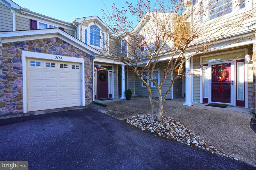 Welcome to 18881 Forgotten Harbor Court #204 in Woods Cove! This well-designed 3-bedroom, 2-bath condominium features vaulted ceilings, an open floor plan, and a desirable split bedroom layout that offers added privacy for owners and guests alike. The kitchen, dining, and living areas flow seamlessly, creating a bright and inviting main living space ideal for both everyday living and entertaining.  An L-shaped sunroom fills the common area with natural light and provides flexible additional living space—perfect for relaxing, reading, or enjoying morning coffee. The private primary suite includes an en suite bath and walk in closet, while two secondary bedrooms offer versatility for guests or a home office. A one-car garage adds convenience and extra storage.  Enjoy low-maintenance living in the sought-after Woods Cove community, close to shopping, dining, and area beaches.