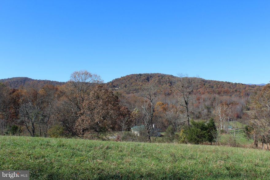Gorgeous 7.85 AC lot w/ pastoral & mountain views.  No HOA, no restrictive covenants and road frontage.  Great lot to build your dream home in a peaceful country setting.  Surrounded by farms and a year-round creek/stream.  Conventional perc. On Culpeper/Rappahannock line.