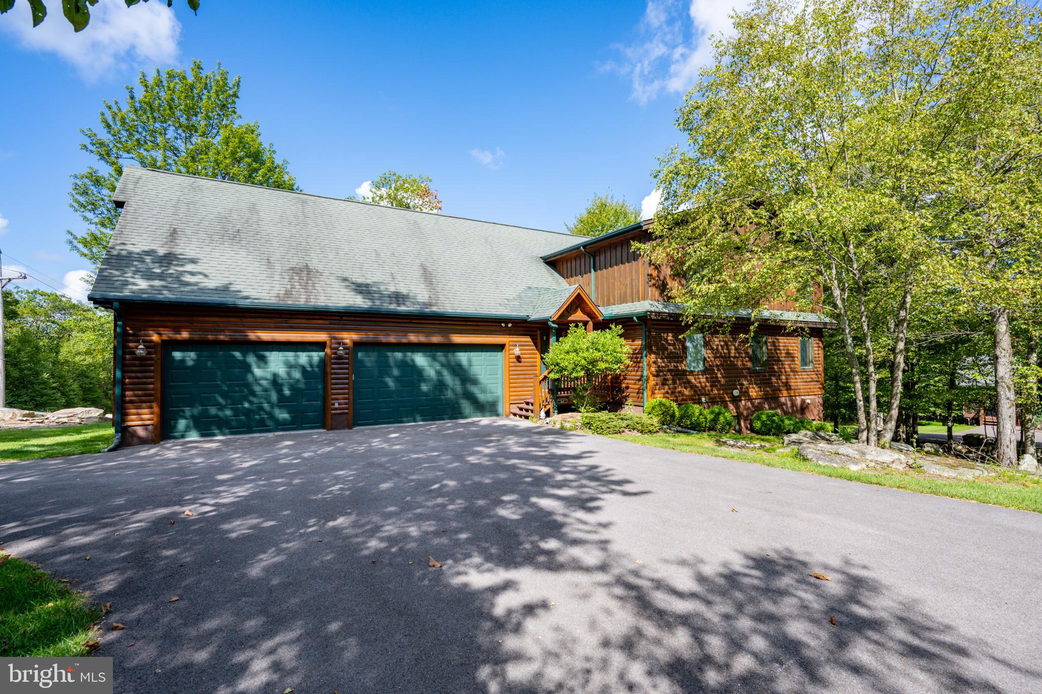Mountainside Luxury Log Home. "Boulder Escape" is a stunning 7-bedroom, 4.5 bath lake access home on 1.6 acres in this prestigious mountaintop community. This income-producing property, offering over 5600 square feet, has an open concept floor plan with amazing expansive space on all levels. You will find an easy flow throughout the living, dining, and kitchen areas. Comfort and ambiance are first and foremost in the great room, with soaring vaulted ceilings, recessed lighting, hardwood floors, and native stone accents surrounding the stylish recessed fireplace. The kitchen is the "Heart of the Home" and can accommodate many! A large granite-topped island, high-end appliances, and a huge pantry provide the best for entertaining with your gourmet style. The primary suite with an oversized walk-in closet is found on the main level. The additional bedrooms are located on the upper and lower levels, providing privacy for all your guests. You will find entertainment with an expansive media room on the upper level and a family room/game room on the lower level. Enjoy a game of pool and then hop into your hot tub to soak and relish in the beauty of your mountain setting! The 3-car attached garage provides plenty of room and storage. The Mountainside Club enables easy access to Deep Creek Lake and its amenities. Whether investing, yearning for a vacation retreat, or needing a full-time residence, look at this turn-key property to "fit the bill"!