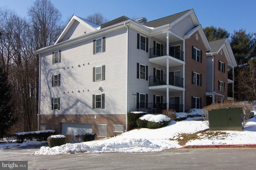 TOP FLOOR, 2 bedroom, 2 bath condo with AN ASSIGNED PARKING SPACE IN THE COVERED GARAGE!! Get the best of both worlds with no one living above you stomping around, and your car in a covered parking garage, out of the cold, wet elements!  This condo is move-in ready with BRAND NEW carpet and a FRESH paint job!! You will love the open floor plan where the living room boasts a slider to the outside covered porch. A great place to sip your morning coffee! The guest bedroom is served by the hall bath and the HUGE primary bedroom is served by its own walk-in closet and primary bathroom. The  primary bath has a walk-in shower.  The kitchen is large enough for an eat-in area. The elevator takes you straight from your condo to the parking garage underneath the building. No need to ever do steps. There is also a bonus storage closet in the garage for this unit. This vibrant over 55 condo has a community room which features a kitchen, meeting room, craft room, pool table, and gym! Enjoy all the fine dining and shopping Eldersburg has to offer!