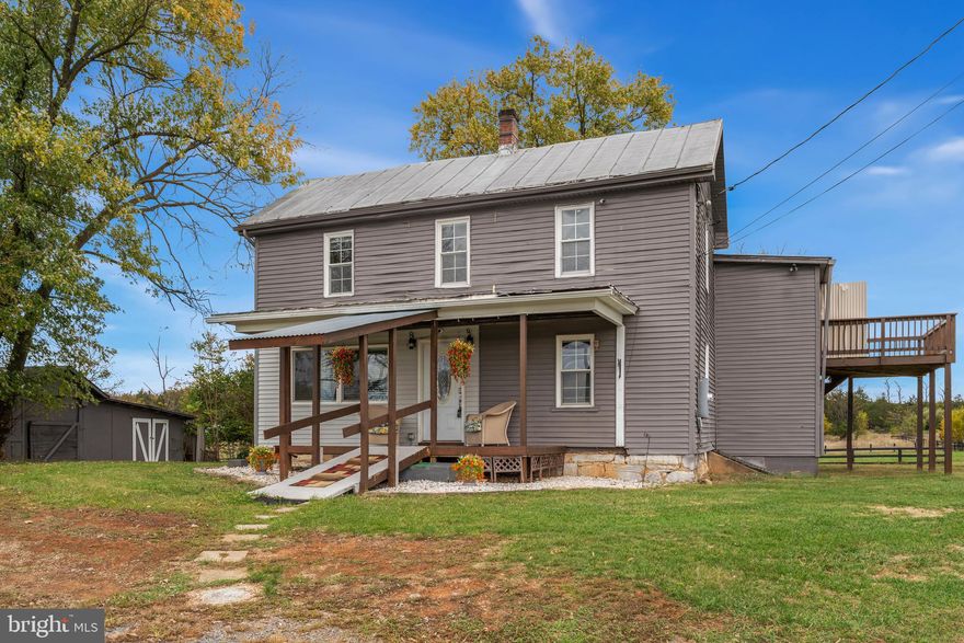 One-of-a-kind is an understatement here and a recent price improvement makes a great property even better. This home was originally built in 1774 and remained in the founding family's care until 2024. The first floor was remodeled in 2022 and much of the top floor a few years previous, many of the original features of this home can still be found inside as well. The 3ac property sits on a quiet country road and is fully fenced and ready for you. Homesteading, goats, chickens, horses - yep, that works here! Just want to relax away from the bustle of the city, this is a great place to do that too, with easy commute routes to NorVA, DC, MD areas. A quick drive takes you to Charlestown, Harper's Ferry, Winchester and to Summit Point racetrack.  The property is great for multi-generational living and currently boasts a 1st floor, 1 bedroom in-law apartment and 2nd floor 2 bedroom apartment.  Each floor is self-contained with kitchen, full bath, laundry/mud room & family rooms large enough to accommodate an eat-in area.  Don't need that extra kitchen, the 2nd floor family room combined with the existing kitchen could become the primary suite of your dreams. Each level has a separate entrance with the original interior staircase to tie them together.  There are ductless mini-split units on both floors to provide multiple zone heat and air conditioning and additional wall mounted heating units on each floor to keep you extra cozy on those cold nights. The bedrooms are spacious and well lit. Modern plumbing and 200amp electric service blends side-by-side with original details like bead-board, wood ceilings, crown molding, window molding. Original doors and hardware can still be found in many rooms. There's gorgeous original hardwood floors being protected under the LVP in the 1st floor entry room along with the original fireplace mantle. Additional original hardwoods will be found under the LVP in several other rooms as well. The main part of the home was originally a log home and these logs are still there under the drywall in some of the rooms. The farm features 2 fully fenced pastures and 3 paddocks, the existing outbuildings will need some work but there are two livestock barns, a small kennel, a large carport and three equipment sheds. You'll really enjoy the updated vinyl clad windows. The property is currently being used by the neighboring greenhouse business as an office and they will be vacating before settlement. The adjacent 71ac farm is protected agricultural land and was recently used as a horse show facility.  The stone drive leading to the pasture behind the home is private and belongs to this property. It is NOT shared by the farm adjacent to or behind the property. The previous owners had goats and horses on the property, but it's been several years, so pastures are ungrazed.