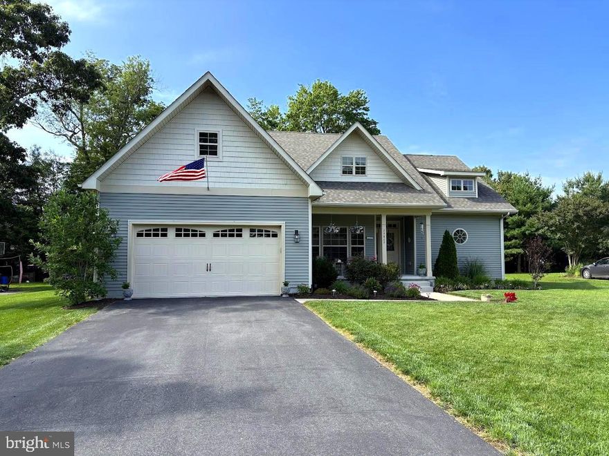 These Motivated Sellers Have Slashed The Price On This Beautiful Home!  Amazing 4-bedroom, 3-full bath home for sale in the Bayfront Community of Bay Colony which is nestled along the Indian River Bay. This resort-style neighborhood offers exceptional amenities including their own private bay beach (relax, fish or crab), community boat ramp, clubhouse, in-ground pool, as well as tennis and pickleball courts. Ideal for outdoor and water enthusiasts, Bay Colony also sits just across the street from Cripple Creek Golf and Country Club, perfect for those who enjoy a round of golf in a scenic setting.
This spacious home offers approximately 2,549 square feet of well-designed living space. The upper level en-suite featuring a large bedroom with a private bath and walk-in closet, while the main level includes a generous primary en-suite with walk-in closet and luxurious bath featuring a soaking tub, tile shower, and double vanity. Two additional bedrooms on the mail level are located on the opposite end of the home, separated by a hall bath with a tub/shower unit and a single vanity. As you enter the front door, the welcoming foyer leads to a formal dining room and a living room with cathedral ceilings. The eat-in kitchen is a chef’s dream with a large 6-person counter, Wolf soft-close cabinets, stainless steel appliances, gas stove/oven, built-in pantry, and a dining area. Just off the kitchen is a separate laundry room which provides access to the attached two-car garage. A spacious screened porch with roll-down vinyl curtain panels overlook a beautifully landscaped backyard complete with a large patio, outdoor shower with hot and cold running water, and a 20x14 barn with electric and heat. Additional features include whole-yard irrigation, encapsulated crawlspace with dehumidifier, and irrigation controls are conveniently housed in the barn.