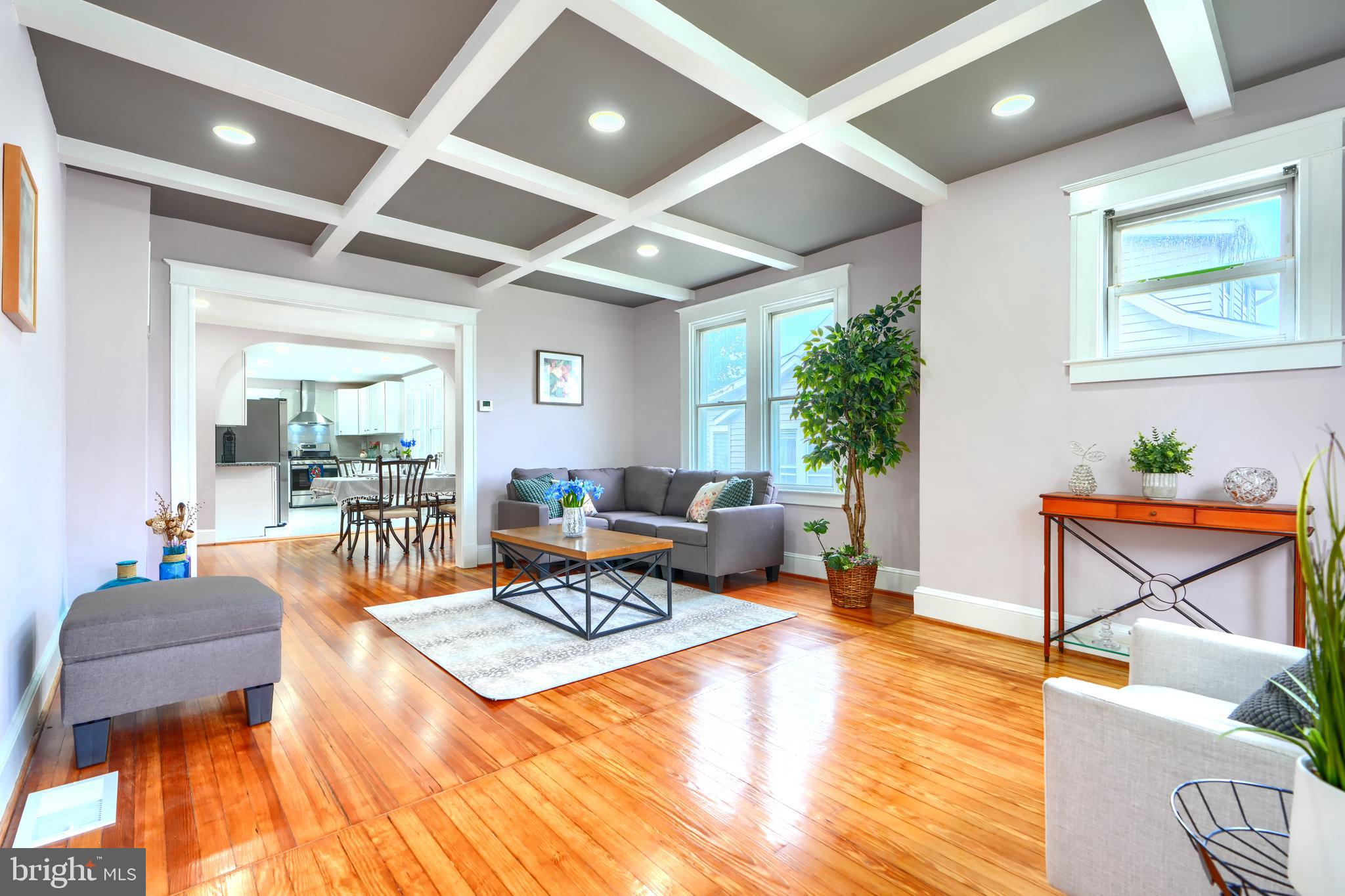 Welcome to this beautifully renovated four-bedroom, two-bath ranch-style single family home offering a perfect blend of classic charm and modern updates. Step into the inviting sitting room at the front entrance, leading into a spacious living room featuring stunning coffered ceilings, recessed lighting, and original hardwood floors that continue into the formal dining room. The kitchen boasts ceramic tile flooring, brand new stainless steel appliances, sleek quartz countertops, and ample cabinetry. Two generously sized bedrooms and a full bathroom complete the main level. Step out the back door to enjoy outdoor living on the low-maintenance Trex deck overlooking a huge backyard—ideal for entertaining or relaxing. The fully finished lower level adds incredible versatility with a large family room, two additional bedrooms, a home office, a second full bath, and a laundry area with a brand new washer and dryer. Additional features include a two-car driveway, brand new electrical and plumbing systems, and completely updated kitchen and bathrooms. This home is move-in ready and offers everything you need for comfortable, modern living.