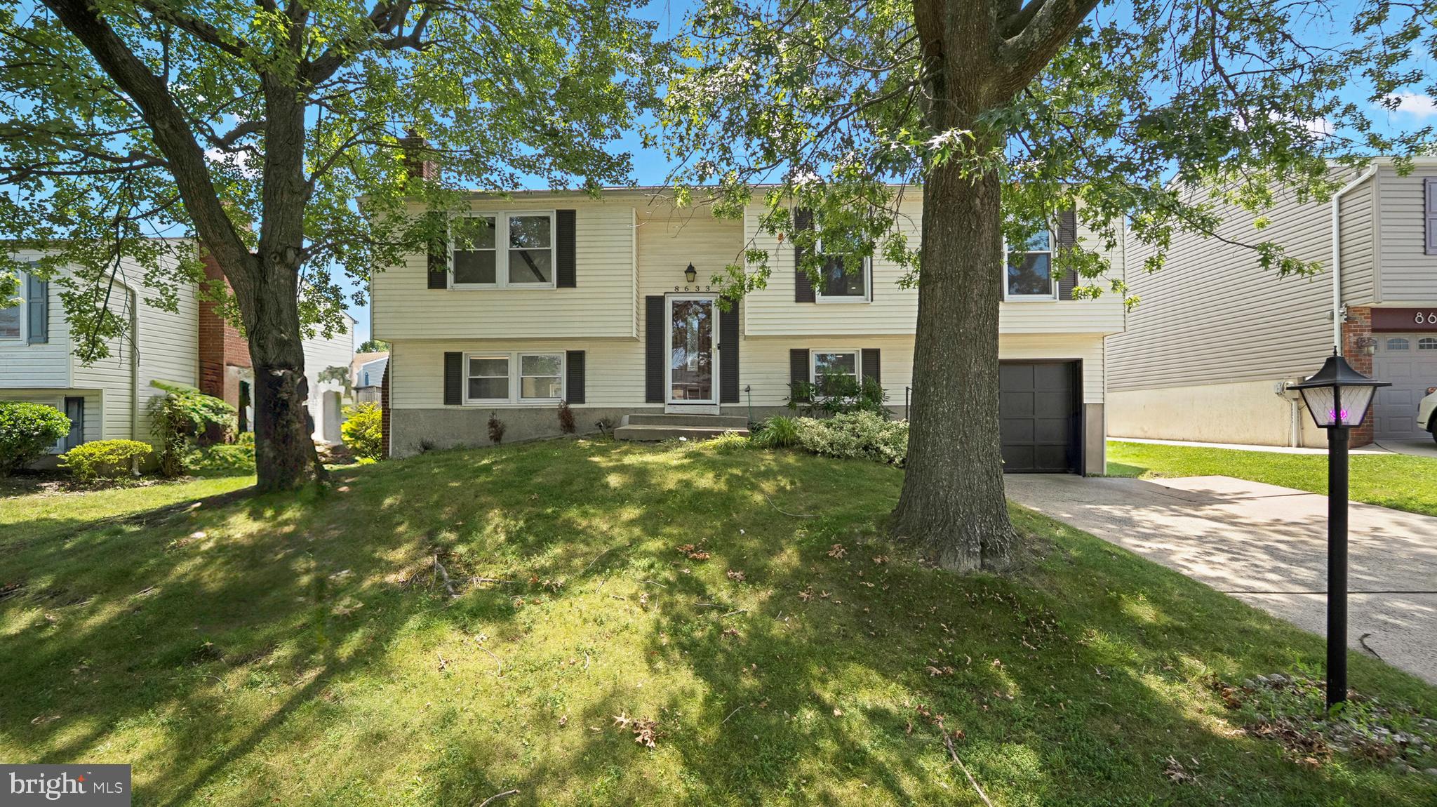 Step into timeless charm at 8633 Saxon Circle, where classic architecture meets modern updates. This split-level home features four spacious bedrooms, two full baths, and a stylish half bath. The kitchen offers plenty of cabinet space and a breakfast nook with backyard views. Downstairs, enjoy a cozy fireplace and direct access to a patio that’s ideal for summer barbecues or quiet evenings. The oversized garage and custom closet systems add functionality, while the location—just minutes from shopping, dining, and for summer fun, the Coppermine White Marsh Swim Club is just a short drive away, offering a large pool, splash area, and seasonal activities for all ages.