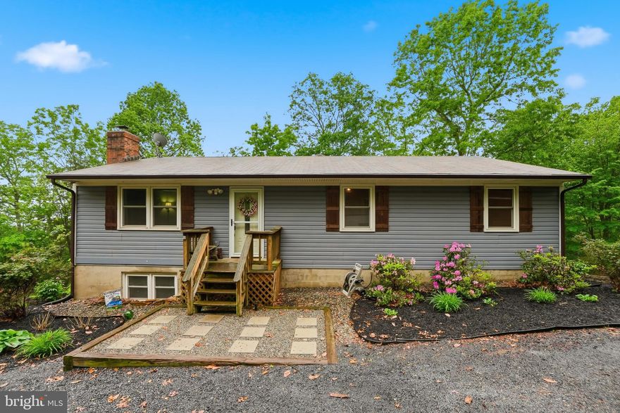 Move-in ready, updated, and private—with a view. Enjoy pride of ownership in this well-cared-for home on a quiet dead-end street. You’ll love the refreshed finishes, flexible lower level, and the outdoor space that gives you room to breathe—plus a fabulous view. Features include: Updated kitchen with granite slab countertops, ceramic flooring, and newer appliances, Bamboo flooring in living room, hall, and bedroom area; ceramic tile in dining room, Updated bathrooms; newer carpet, Finished lower level with floor-to-ceiling fireplace and flexible space (possible 4th bedroom) + half bath, Updated laundry area; two storage sheds, Roof & gutters replaced 2017, Gutter guards 2021, New 50 gallon water heater 2025, 1/2 acre+  lot offering privacy, fabulous views and fresh mountain air