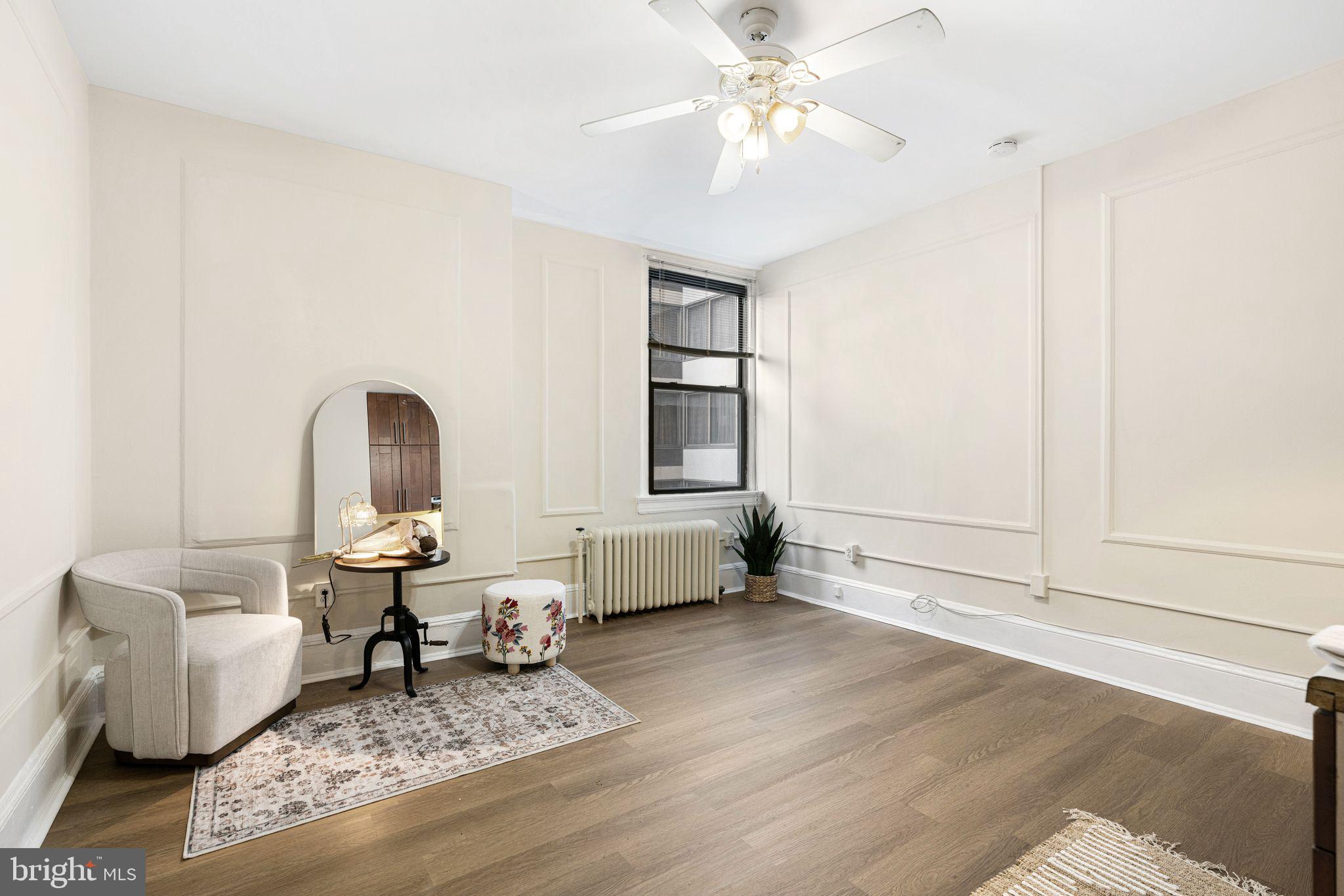 New to the market, this FRESHLY PAINTED studio exudes modern charm with FLOOR TO CEILING KITCHENETTE hosting extra wooden cabinets and NEW LAMINATE FLOORING. Owner is open to providing concession to Buyer to buy 1 point on loan. Studio's entryway has hallway with a coat rack and black & white ceramic tiled bathroom with a shower stall. Enter further, an expansive wall space leads to the studio's 342 SQ FT WIDE OPEN FLOOR PLAN. Its high ceiling, accented with a ceiling fan, and central placement of the kitchenette elongate the space. Window has a gorgeous view of the Kimmel Center. The secret to this elegant space is keen use of its walls for furniture placement and additional storage. Studio w. kitchenette includes mini refrigerator, central air and radiator heating, and storage closet. CONDO FEE COVERS ALL UTILITIES including cable TV, security & concierge, fitness center, free wi-fi in lobby and community recreation room, bike room and additional storage in basement. Excellent location in Washington Square West by the theater district catacorner to the Academy of Music, the Bellevue, walking distance to Restaurant Row, Rittenhouse Park, Washington Square, Antique Row w. additional shopping and dining nearby. Great for a second residence in the city, relocators to Philly and fans of small spaces. Access to Broad Street and Patco lines, regional rail train routes to airport and suburbs, I95, 76/Route 1 expressway.