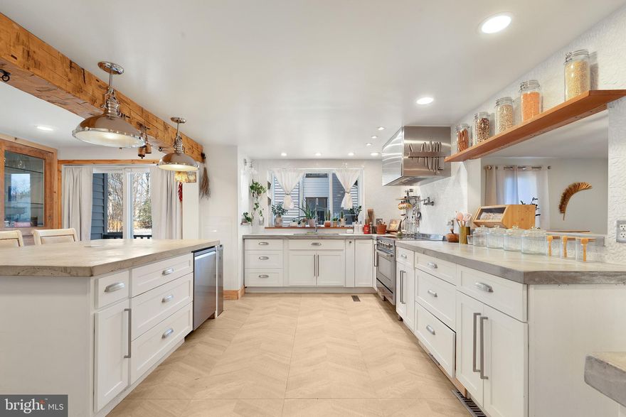 Welcome to this gorgeous 5-bedroom, 3-bathroom home in the heart of Severn, where elegance, space, and modern comfort blend seamlessly. Spanning 4,999 square feet, this home offers an open floor plan designed for effortless living. As you step inside, you’re greeted by gleaming hardwood floors and a breathtaking two-story family room with a brick fireplace, creating a warm and inviting ambiance. The vaulted ceilings enhance the sense of space, allowing natural light to flood the home.

The renovated kitchen is the heart of the home, designed for both culinary creativity and cherished family gatherings. Featuring luxurious concrete countertops, a custom mosaic backsplash, stainless steel appliances, and a spacious kitchen island, this space invites loved ones to come together—whether for casual breakfasts, lively dinner parties, or holiday celebrations. The kitchen/dining combo allows seamless conversation and connection, making every meal a memorable experience.

Upstairs, the primary suite provides a tranquil retreat with a spa-like bathroom, complete with a separate soaking tub and shower. Four additional bedrooms offer ample space for family, guests, or even a home office.

The fully finished basement is an entertainer’s dream, offering additional living space that can serve as a media room, gym, or guest suite, complete with a full bathroom for convenience. Step outside to your expansive brick patio, where you can enjoy outdoor dining and relaxation while overlooking the huge backyard, which backs to lush trees and features a charming small pond. Situated on 0.79 acres, this property provides ample space for outdoor activities, gardening, and more—all with no HOA restrictions, giving you the freedom to make this home truly your own.

This home is also designed for convenience, featuring a spacious 2-car garage with plenty of room for storage. Plus, with ample additional parking, your guests will always have a place to park when they visit.

Perfectly situated, this home is just 10 minutes from BWI Airport, 2 minutes from Severn Danza Sports Park, and 10 minutes from Arundel Mills Mall, offering easy access to shopping, dining, entertainment, and travel. Whether you’re looking for outdoor recreation, top-tier amenities, or a peaceful retreat, this home offers it all.

With a prime location, luxurious finishes throughout, an expansive lot, and NO HOA, this is more than just a house—it’s THE home you’ve been waiting for. Don’t miss your chance to make it yours—schedule a private tour today!