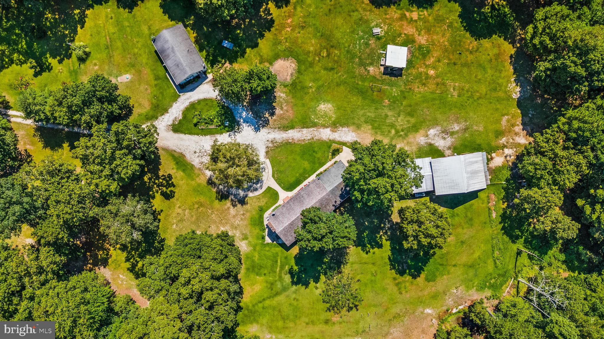 Opportunity abounds! This property is a rare find with two homes nestled on one four acre parcel with separate mailing addresses. This beautiful parcel is minutes from both Berlin and Snow Hill as well as Public Landing. The smaller of the two homes is situated on the left side of the property, offers 3 bedrooms and 1 bathroom and a conveniently located storage shed/outbuilding. Across the circular driveway surrounding a majestic weeping willow is the primary home that also has 3 bedrooms and full bathroom as well as a laundry / mud room with an attached two car garage. There are so many little things that make this property special including the well thought out flowers / garden and large barn. This is a great opportunity for an investor, someone looking for a homestead with an in-law suite or perhaps rental income. This unique property offer serenity, privacy and plenty of room for just about anything you can dream up.