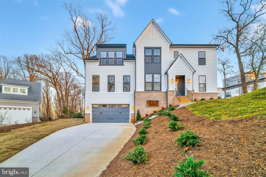 Discover an extraordinary new-construction by Stanley Martin Custom Homes. Fully custom single-family residence—a modern-transitional architectural gem with a refined European vibe. Perfectly positioned on a hilltop with sweeping views (including the Washington Monument on a clear day), this home blends timeless sophistication with exceptional livability in one of the region’s hottest neighborhoods. Just minutes from two Metro stations (Orange & Silver Lines), I-66, I-495, Tysons Corner, top schools, and premier shopping.
With over 6,400 square feet of usable space, this home features a vast, open floorplan filled with natural light from large windows throughout and 10-foot ceilings on the main level. A generous foyer opens to spacious formal and informal living areas—the living room, dining room, great room, and sunroom—elegantly connected through dual sets of all-glass French doors and a striking two-sided fireplace. Wide white-oak plank hardwood floors flow through the entire home, complemented by oak stairs that seamlessly connect all floors with modern craftsmanship.
The grand chef’s kitchen is a true showpiece, offering abundant daylight, high-end appliances, a custom hood, open shelving, and thoughtful design for both everyday living and entertaining. A fully equipped second kitchen/scullery is discreetly tucked away, providing extensive pantry storage and extra prep space. A main-level bedroom with full bath adds flexibility for guests or multigenerational living. At the rear, a spectacular 16-foot all-glass sliding door opens to a covered architectural deck, extending the living space outdoors.
Upstairs, a bright loft family room leads to an impressive owner’s suite appointed with designer finishes. The spa-like bath features a freestanding soaking tub, oversized glass shower with rain head, premium fixtures, and exquisite materials. The his-and-her dream dressing rooms include extensive closet systems and lounge areas. Step directly onto the private second-floor deck to enjoy sunshine and breathtaking views. Three additional generous bedrooms—each with an ensuite or Jack-and-Jill bath—and a beautifully finished laundry room complete the level.
The lower level, nearly full walk-out, offers a massive recreation room, media/family room zone, a wet bar, an additional bedroom and bath, plus a second laundry closet. Part of this level can easily function as an in-law suite or private rental.
With designer finishes throughout and impeccable craftsmanship, this residence delivers luxury, functionality, and location in perfect harmony—a rare opportunity in a truly coveted neighborhood.