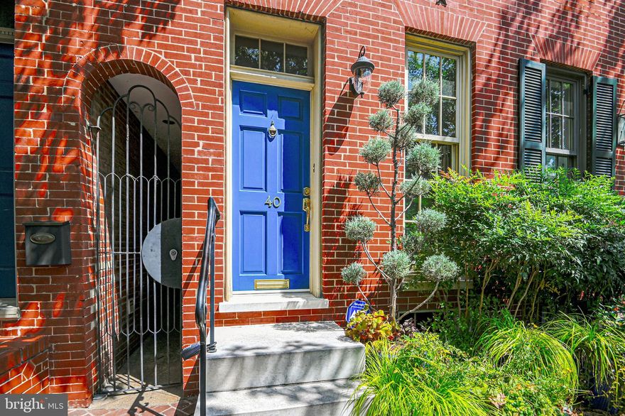 1 year paid parking space in lot right behind property. Situated in Federal Hill's Historic District, this elegant home with contemporary flair has a spacious floor plan filled with natural light and wide plank wood floors.  Main floor hosts an eat-in kitchen with stainless steel appliances & granite countertops, a separate dining room, and a sunken living room with wood burning fireplace. Wall of windows lures you out to a beautiful landscaped garden & patio. Master & second large bedroom with wood burning fireplace, along with a renovated bath and laundry area are located on the 2nd level. Third bedroom and office/sitting area, plus easy access to spacious roof top deck are on the 3rd floor. Recent replacements include HVAC condenser, water heater, washer/dryer and refrigerator.