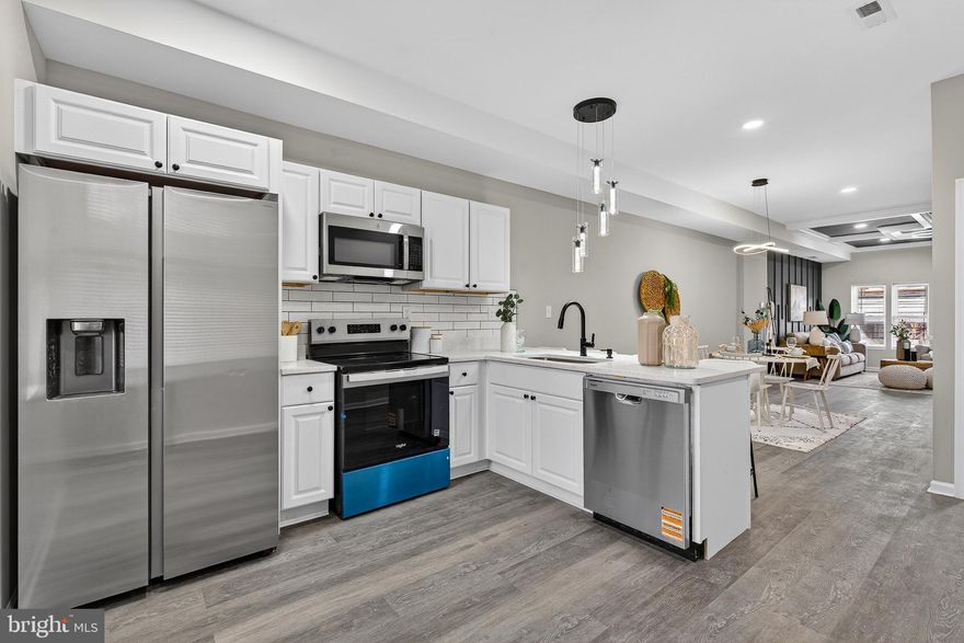 Step into this stunning, fully renovated home where contemporary design meets everyday functionality. Every inch of this property has been curated with high-end finishes and a "brand-new" feel that is ready for you to move right in. The open-concept kitchen is a showstopper, blending sleek aesthetics with premium utility. Sparkling white quartz countertops paired with a classic white subway tile backsplash and dark grout for a modern edge A full suite of stainless steel appliances, including a side-by-side refrigerator, microwave, and a range featuring a stylish blue accent panel. A deep stainless steel under-mount sink with a matte black gooseneck faucet, complemented by custom pendant lighting and elegant white cabinetry.
The oversized peninsula offers a built-in breakfast bar, perfect for morning coffee or entertaining guests while you cook. The living and dining areas flow seamlessly, highlighted by trendy grey wide-plank flooring and a neutral color palette that makes the space feel bright and airy. Unique light fixtures, including a dramatic multi-cylinder glass pendant, add a touch of artistic flair. Large windows throughout the home invite an abundance of sun, highlighting the crisp, clean lines of the interior. Spacious layouts with plush, wall-to-wall carpeting for maximum comfort. Custom floor-to-ceiling marble-style tile work featuring a stunning gold honeycomb inlay and a river-rock pebble floor. High-end brushed gold fixtures, from the rainfall-style faucet to the hardware and towel racks, provide a cohesive, luxurious look. New white vanities and bright LED vanity lighting ensure a fresh start to every day.
This home is a rare find, combining bold designer choices with a warm, inviting atmosphere. Schedule your tour today!