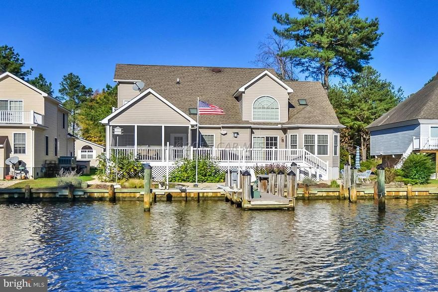 AMAZING PRICE! Waterfront Custom (by Brunori) 4+ bedrooms, 3 full baths, over 2,800 sq.ft. Multiple guest space w/bath for ea. family. $30,000 recent upgrades: two heat pumps, multi-burner gas cooktop w/grill, Silestone bioguard counters, touchless faucet, instant hot, wine cooler. NEW: vinyl railings, porch screens, Hunter Douglas blinds, Anderson front door. First floor: master suite opens to porch/deck, bonus flex office/den/5th bedrm w/built-in ''Murphy''(pull-down)bed. Entertain on waterside decks, patios, screen porch, upper star-gazing balcony. Dock, lift for two boats/jet skis. The 2nd fl. 25'X10'room has great guest space/hobby. Stacked stone foundation, side load garage, beautiful year'round perennial landscaping. Quality features thru'out! Furniture negotiable.