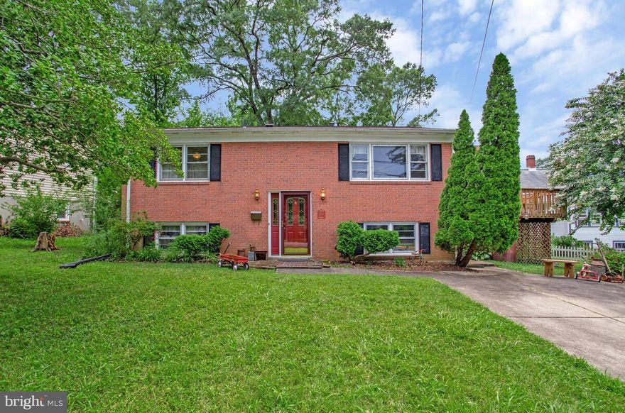 Welcome to this spacious and beautifully maintained split foyer home featuring 4 bedrooms and 2 full baths. The main level offers a bright, layout with hardwood floors and updated full bathroom showcasing a modern walk-in shower. The kitchen boasts stainless steel appliances and opens to a spacious deck — ideal for entertaining — complete with a retractable awning for shade on warm days. The finished lower level includes a private bedroom, a full bath, family room with electric fireplace and a versatile laundry/workroom, perfect for guests, home office, or additional storage.  Additional highlights include a driveway with parking for two cars & shed in backyard.  Close to bus routes, Metro & shopping, Lake Artemesia. This move-in-ready home has everything you need in a layout that truly works for family/friend entertaining.  (See Special Features Sheet outlining appliance ages, recent updates, and warranty information in documents)