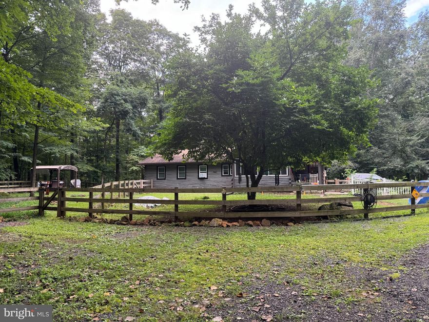 Owner is a motivated seller so take this opportunity to own a secluded log well maintained log cabin in the woods.  Driving down the lane to the log cabin brings natures best!  This custom-built log cabin sets on 3.27 acres. You can spend evenings in the enclosed glass solarium staring at the sky or convert this into a greenhouse or spend your evening in the newly renovated screened porch.  When you arrive, you will notice the log cabin has been recently re-stained and treated. Newly installed windows and fencing surround the flatter grassy area where a pergola is perched for a forest view. Upon entering through the original wooden door, you will see an open floor plan containing a great room and kitchen. The antique Porcelain German wood burning stove set against the stone fireplace is sure to catch your eye along with the newly installed vinyl flooring running throughout.  A newly built bathroom, tiled but not completed, allows you to finish the bathroom of your dreams. A wall has been added to create a dual use room, bedroom/ study with its own private entrance.  An attached two car garage can be entered through the vestibule, allowing access to both the storage over the garage and crawl space just to the right of the outside the garage doors. Circling back through the kitchen and great room you enter the hall covered with rustic rock where you find two bedrooms and a full bathroom ready for use. To the right you will find the master bedroom waiting for your finishing flair, vinyl flooring has been purchased but not yet installed.  Across the hall you will find another bedroom where the launderette has been located for convenience. 
The property is perfect for anyone seeking peace, privacy, and potential - whether as a full- time residency or a weekend retreat or investment. The current owner will miss the solitude and beauty of the woodland hideaway. Now it's your turn to claim this piece of heaven.
Opportunities like this don't last. Schedule your showing today!
This is an as is sale, but homeowner is offering a one-year home warranty.

****** A multitude of updates have been done since the owner purchased the property in 2020. A list can be found in the document section. ******
Daughter works from home M-F, showings must be after 4:30 during the week.