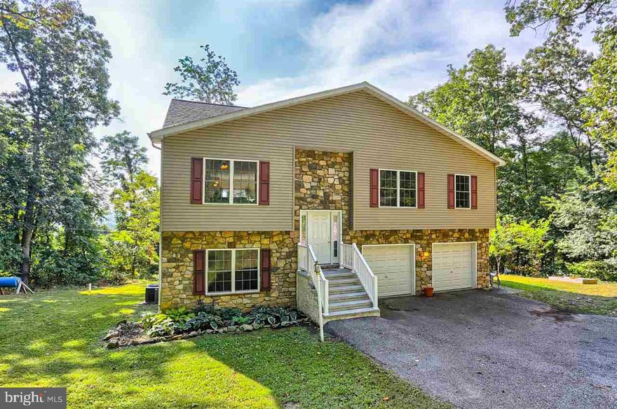 Tucked away on a private & wooded 0.5 acre lot you will discover this 4BR 3BA Split Foyer home. Great views can be enjoyed from the private rear decks! Open fl plan w/lots of natural sunlight thruout. Kit w/Ctr Island & Door to Deck. DR w/Gas FP flows easily into the Kit ideal for entertaining. Mst Ste w/Door to Deck & Private Bath. Finished LL features BR, Full Bath & FR w/Door to Deck. OS 2 Car Gar w/Side entrance. Home Warranty! Central Schls.