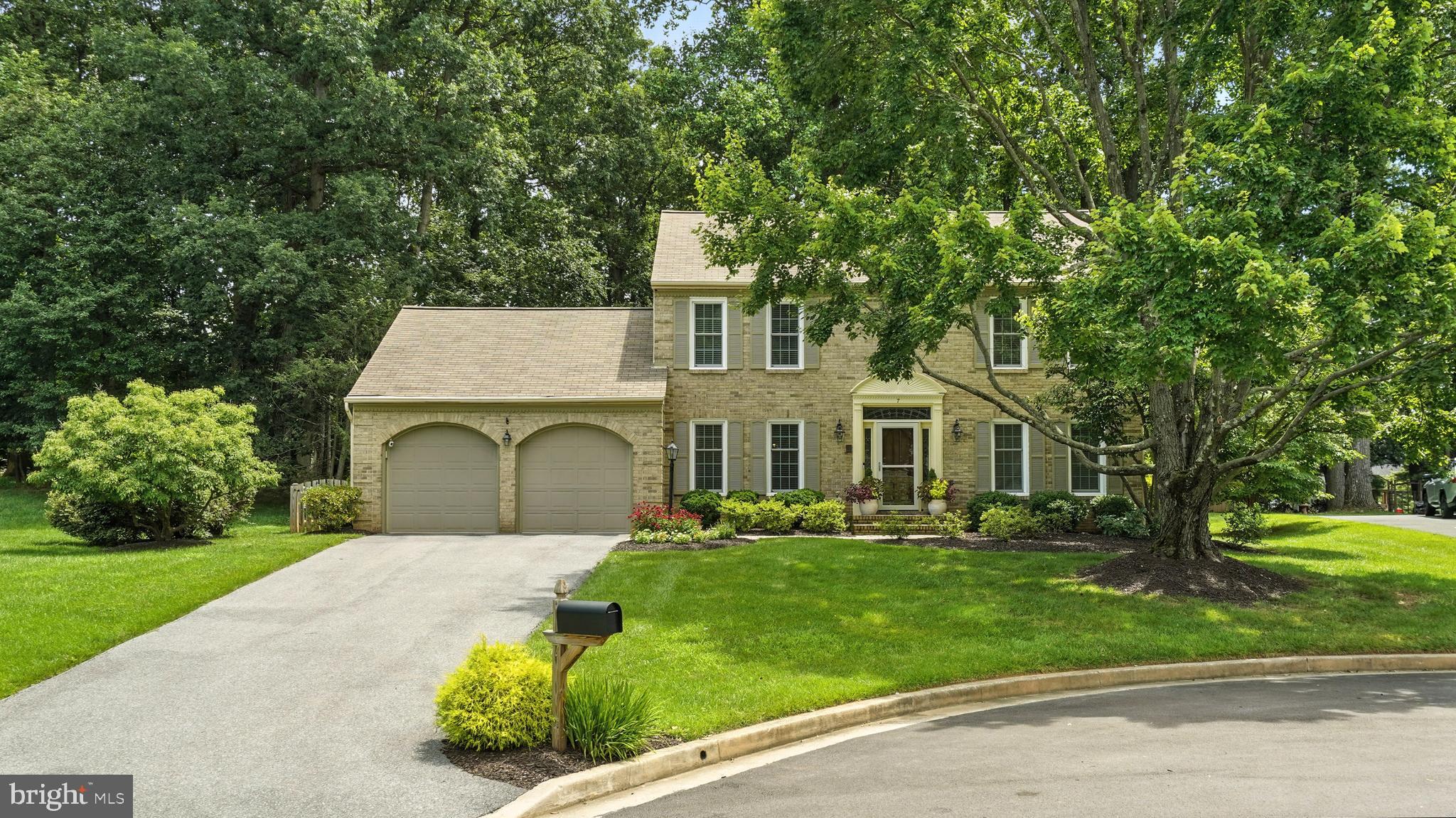 Welcome to this beautifully updated brick-front home offering over 4,100 finished SQFT of living space, nestled on a peaceful 0.47-acre cul-de-sac lot. With 4 spacious bedrooms upstairs and a versatile 5th bedroom in the fully finished lower level, this home provides space, function, and timeless style. The main level showcases gleaming hardwood floors, a bright sitting room with French doors, a formal dining room, and a stunning eat-in kitchen featuring a center island, granite countertops, a Kitchenaid warming drawer, gas cooktop, range hood, convection microwave, and stylish pendant lighting. The cozy family room boasts a gas fireplace with a brick mantle and two skylights for natural light. A spacious pantry with barn door, mudroom with Samsung washer/dryer, and access to the attached 2-car garage complete the main level. Upstairs, the primary suite is a true retreat with hardwood floors, a walk-in closet with attic access, and a luxurious en-suite bath featuring a soaking tub, a glass-enclosed shower, and a renovated vanity. Three additional bedrooms with carpet and ceiling fans share a full hall bath. The walkout lower level is perfect for entertaining with vinyl floors, a large rec room with wet bar, quartz counters, wine fridge, and sink, and a 5th bedroom or private office. You'll also find a utility room with a 2018 Carrier furnace and 2017 water heater, dual 200 amp panels, radon fan, sump pump, and two large storage rooms. Outside, enjoy the tranquil setting with a stone patio, rear Trex deck with vinyl railings, and screened-in porch with vinyl flooring—all overlooking a fully fenced backyard. The driveway accommodates up to 6 vehicles, in addition to the attached 2-car garage. Don’t miss your chance to own this spacious, thoughtfully upgraded home in a prime location!