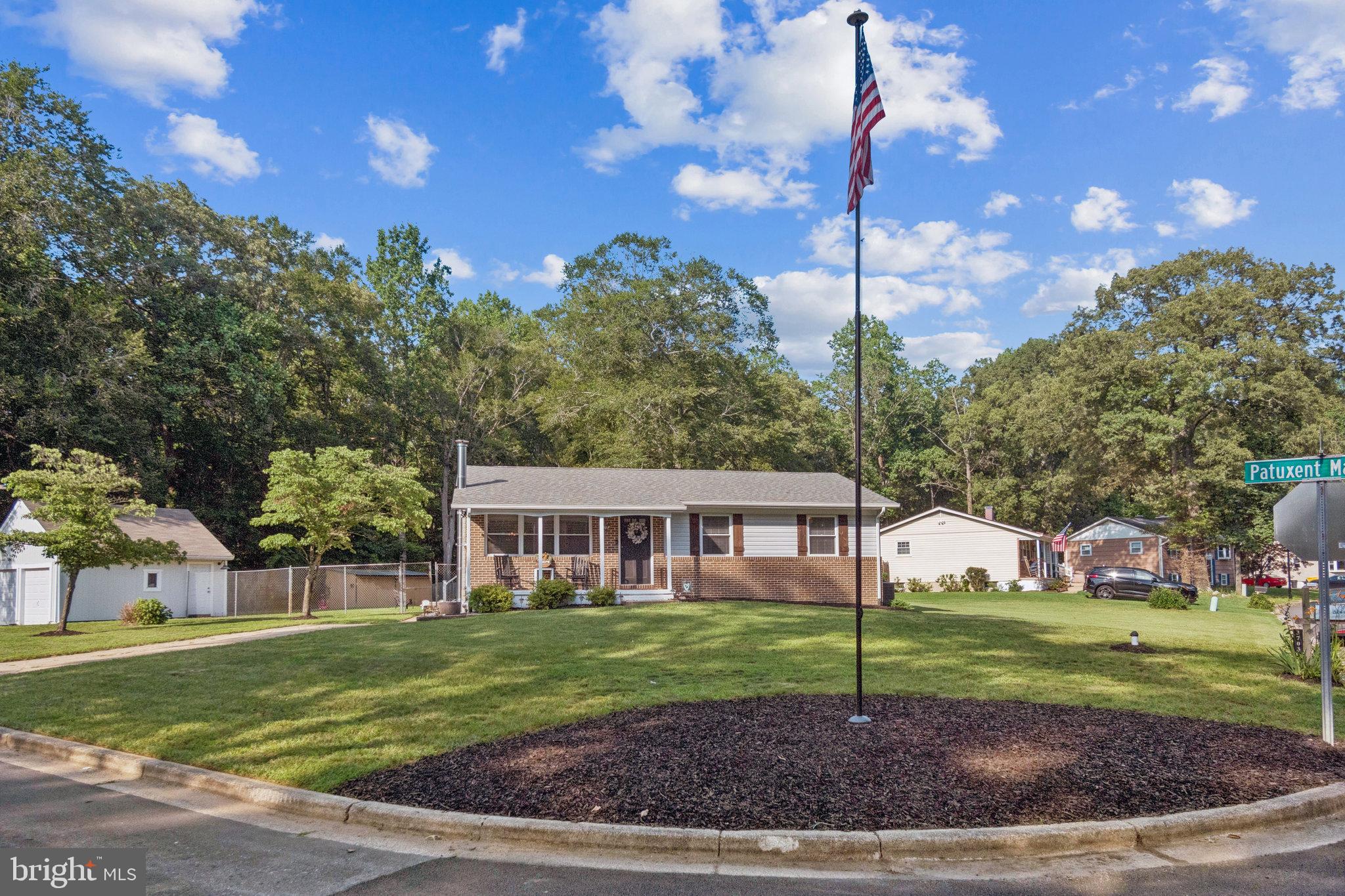 NEW IMPROVED PRICE OF $559,900!! Here is the home you've been waiting for! Lovely rancher boasting over 2,000 total square feet of interior space, 2-car detached garage, nestled on a spacious 0.38-acre corner lot in the highly desirable Patuxent Manor community. With brand-new siding and thoughtful upgrades throughout, this home blends classic charm with modern comfort. Enter into the inviting main level through the bright living room, where you’ll be greeted by all-new flooring throughout the top floor, custom trim work, recessed lighting and a cozy fireplace with mantle. The amazing newly renovated kitchen features wood cabinets with sleek modern hardware, quartz countertops, stainless steel appliances, backsplash, and a custom picture window overlooking the outdoor space. The main level offers three generous sized bedrooms and a fully updated hall bathroom with modern fixtures and tiling. Half bathroom in primary bedroom. The sliding glass door from the dining area leads to a screened-in porch, lower deck and a flat backyard with firepit and storage shed. Finished basement with rec room, laundry/utility room and a walk-out staircase. New septic drain fields, well pressure tank, water heater and water softner. The home is also located in between Renditions Golf Course and Riverwood Park! Homes like this do not last long at all, so be sure to schedule your showing before it's too late!