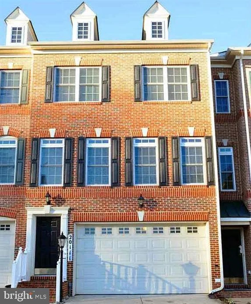 Beautifully maintained luxury brick-front townhome offering nearly 3,000 sq. ft. of comfortable living space with 3 bedrooms, 2 full baths, 2 half baths, and a front-loading 2-car garage. Freshly painted throughout with brand-new carpet.

The main level features an open floor plan with hardwood flooring across the foyer, kitchen, living room, dining room, and powder room. The sunlight-filled living and dining areas include large windows and elegant crown molding. The spacious kitchen is equipped with wood-paneled cabinetry, Corian countertops, a center island, and opens to the dining area with a natural gas fireplace and a glass door leading to a charming deck.

The upper-level owner’s suite includes a walk-in closet, en-suite bath with dual vanities, soaking tub, separate shower, and private access to a second deck. Two additional bedrooms, a full hallway bath, and an upper-level laundry room offer added convenience.

The finished lower level provides a large recreation room with a half bath and sliding door access to the concrete patio—perfect for relaxation or entertaining.

Prime location close to shopping, major highways, the library, and public transportation. A wonderful rental opportunity you won’t want to miss!