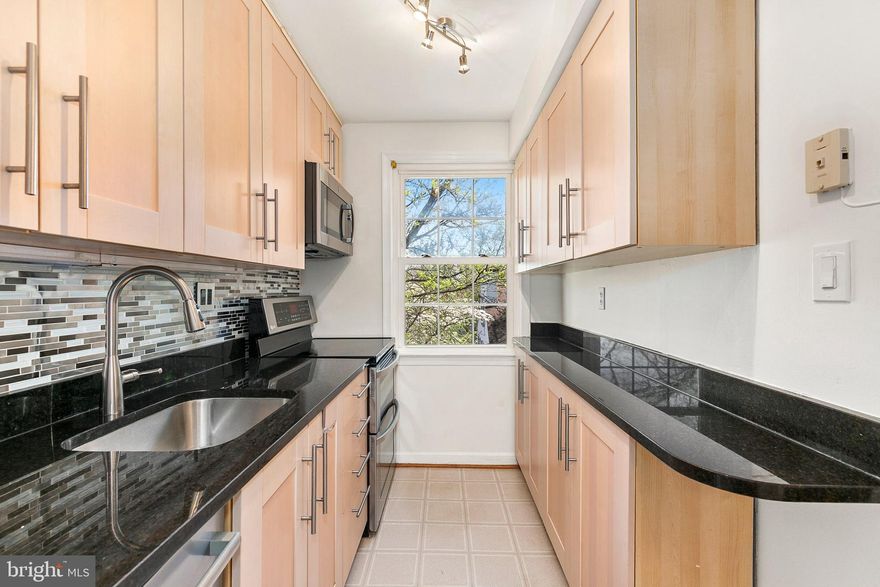 Welcome home to 2211 Washington Ave, Unit 303, in the desirable Rock Creek Commons community of Silver Spring. This freshly painted 2 bed, 1 bath condominium offers comfortable living with thoughtful updates and stylish finishes throughout. The kitchen features granite countertops, stainless steel appliances, an electric range with double ovens, convection microwave, stainless steel and glass backsplash, track lighting, and vinyl flooring, along with attractive cabinetry and under-cabinet lighting by the sink. The adjacent dining area showcases hardwood floors with chair rail and crown molding, creating an elegant space for everyday meals or entertaining. The bright living room also features hardwood flooring, while both bedrooms offer carpeting and generous closets. Bedroom two is enhanced by crown molding and built-in bookshelves flanking the windows, adding character and functionality. The full bath includes a ceramic tile floor and surround with an updated tub liner, and additional storage is provided by a convenient pantry closet. A stackable, frontloading washer and dryer replaced in January 2025 adds everyday convenience, the condo is wired for Fios, and the home also benefits from updated windows. Conveniently located close to Rock Creek Park’s trails, as well as nearby shopping, dining, and entertainment in downtown Silver Spring and Kensington. Easy access to Metro, MARC, major commuter routes, and Washington, D.C. Combining comfort, updates, and a prime location, this home offers exceptional value in a vibrant Silver Spring setting.***MORTGAGE SAVINGS MAY BE AVAILABLE FOR BUYERS OF THIS LISTING.***