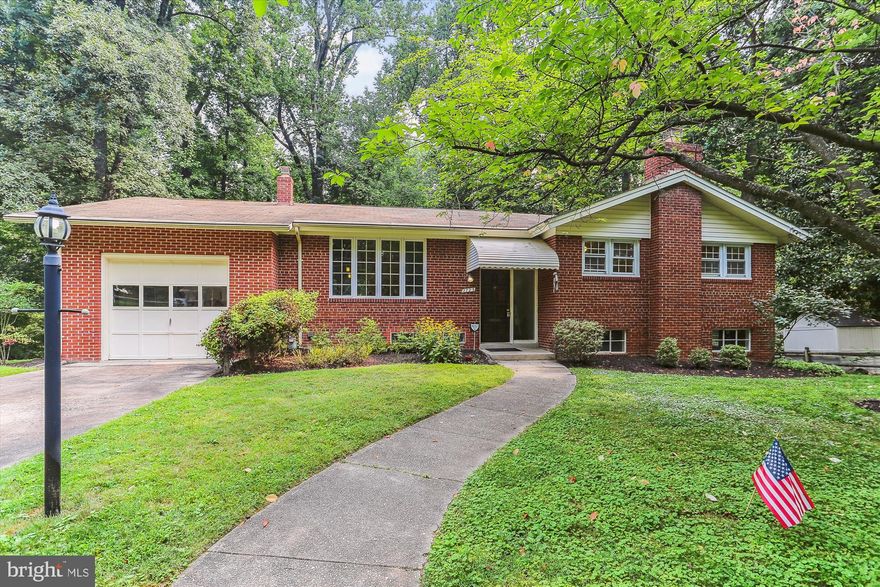 Welcome to a lovely, expanded split foyer brick home with lots of indoor space and a large deck overlooking the wooded backyard. This 3600+ square foot home includes a huge finished and unfinished walk out basement. The main level features an eat-in kitchen, large dining area and magnificently custom built family room with a dramatic vaulted ceiling and brick fireplace. There are also 3 bedrooms and 2 full bathrooms on this level. The hall bathroom features a walk-in accessible tub/shower. The lower level includes a separate office, plus a 4th  bedroom plus another full bathroom. Walking through the lower level huge laundry room there is a storage room and a huge workshop, exercise, bonus room with double doors walking out to the backyard. <br>The location is near everything you need. The Metro Red line is close as are many other commuter routes. You have walking, biking, shopping and restaurants, all within close proximity. Click the virtual tour  link for the must see, virtual tour and floor plans!