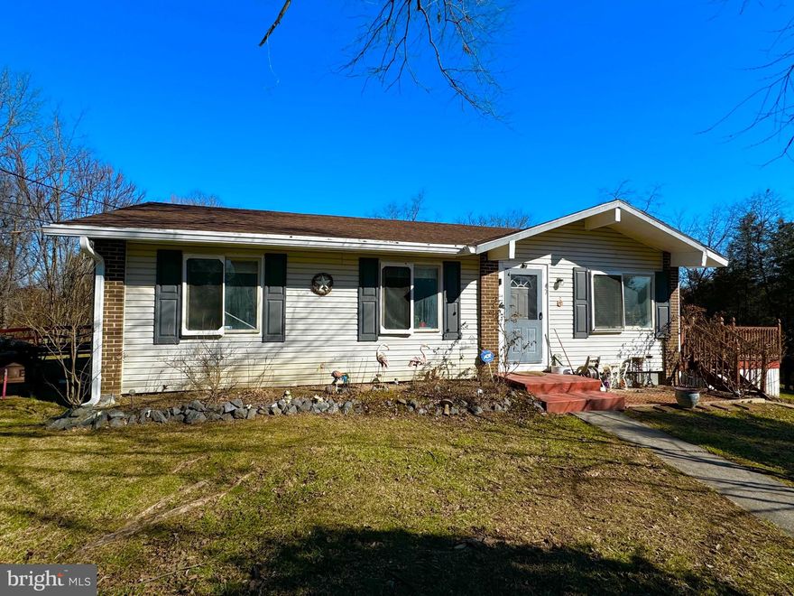 Bring your fishing pole! Public Fishing Access just down the street! No Hoa and only two restrictions! Cozy Rancher on over 1 Acre of ground with oversized Two Car Garage with bonus room above the garage for storage/workshop area. One level living at its best. Don't miss the chance to own this 3 bedroom, 1 bath home. Some features on this home are as follows: kitchen/dining area, living rm, hardwood floors, deck, paved driveway, shingles and gutters are only two years old.  Call today before this home is sold!