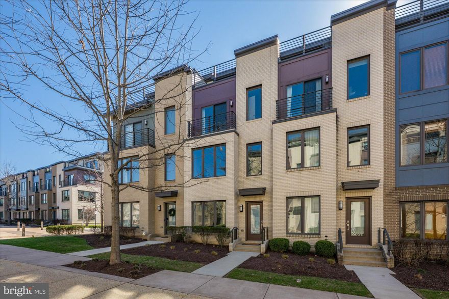 Live in Bethesda for under $1 million!  Enjoy comfortable, modern living in this beautifully designed four-story townhome in the vibrant Montgomery Row Community.  Built in 2017 by the highly regarded EYA Builders, this home showcases exceptional craftsmanship, elegant finishes, and thoughtfully designed spaces throughout—with over $113,150 in upgrades and enhancements. The entry level welcomes you with a spacious two-car garage, mudroom and a bright, versatile space ideal for a main floor bedroom, home office, or gym. Two additional parking passes—one for on-street parking and one for the corporate garage—add extra convenience. The main level features an open-concept layout perfect for both everyday living and entertaining. The gourmet kitchen is equipped with stainless steel appliances, a large center island with breakfast bar, pantry, and a private balcony with a gas line—perfect for grilling. The space flows seamlessly into the dining and living areas, highlighted by a cozy gas fireplace. Upstairs, the third level is dedicated to relaxation, offering a luxurious primary suite with a custom walk-in closet and a spa-inspired bath with a freestanding soaking tub. An additional bedroom featuring a Juliette balcony and its own bath plus a conveniently located laundry area complete this level. The top floor provides incredible flexibility, featuring a fourth bedroom ensuite, additional living space, and access to a stunning rooftop terrace with panoramic views—perfect for entertaining or unwinding. This exceptional home blends luxury, comfort, and convenience, with easy access to I-270, Westfield Montgomery Mall, the Transit Center, the local Preschool, Medical Offices, Shopping, and Dining—an outstanding opportunity to own in Bethesda you won’t want to miss. Located within a LEED-certified community, it also offers the added benefit of energy efficiency and sustainable living.