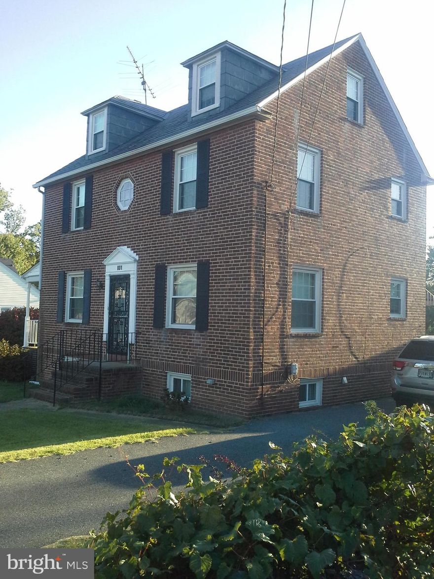 Stately and Classic 4  bedroom 2 bath brick Colonial with full walk-up attic on spacious level lot. Inviting covered side porch  just waiting for your coziest table and chairs. Hardwood floors, updated kitchen and breakfast room or maybe you would convert the space to a HUGE kitchen and gathering area.  All newer replacement windows, full basement with workspace, utility area, ample storage and outside access.  Covered back porch just steps to the oversized 2 car garage with workshop addition.