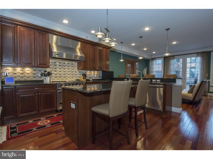 Fabulous townhome on most desirable Queen Village street with Garage parking and an Elevator. With 4 floors of bright living space and 3 separate outdoor spaces-this custom built 6 year young home truly has it all! The spacious state of the art kitchen features custom cabinetry, granite countertops, Viking SS appliances (including a microwave and wine refrig), a center island, as well as a breakfast bar. The kitchen opens to a great family room with Eastern facing windows to bask in the morning sun. A separate formal dining room detailed with molding has french doors which open to a large, private deck. Upstairs relax in the master suite- complete with a gas fireplace, elegant bath with double sinks, whirlpool tub, walk in shower, and a custom walk-in closet or watch the fireworks from your own private patio. Three additional bedroom suites with their own tastefully tiled full baths plus a separate room for an office/playroom complete this home. Covered entry, hardwood flooring throughout, finished basement with storage space, intercom system, interior fire sprinkler system, central vac, and a tax abatement. This will not last!