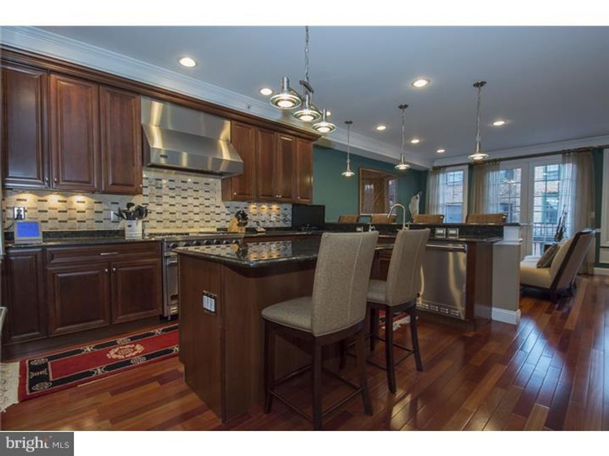 Fabulous townhome on most desirable Queen Village street with Garage parking and an Elevator. With 4 floors of bright living space and 3 separate outdoor spaces-this custom built 6 year young home truly has it all!  The spacious state of the art kitchen features custom cabinetry, granite countertops, Viking SS appliances (including a microwave and wine refrig), a center island, as well as a breakfast bar.  The kitchen opens to a great family room with Eastern facing windows to bask in the morning sun.  A separate formal dining room detailed with molding has french doors which open to a large, private deck. Upstairs relax in the master suite- complete with a gas fireplace, elegant bath with double sinks, whirlpool tub, walk in shower, and a custom walk-in closet or watch the fireworks from your own private patio.  Three additional bedroom suites with their own tastefully tiled full baths plus a separate room for an office/playroom complete this home.  Covered entry, hardwood flooring throughout, finished basement with storage space, intercom system, interior fire sprinkler system, central vac, and a tax abatement.  This will not last!