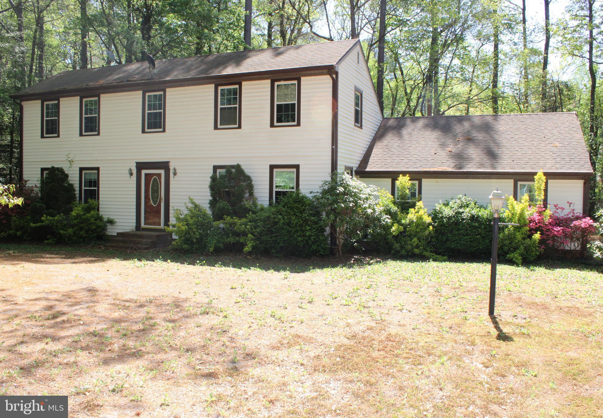 ***Seller will entertain all offers***
Welcome home to your colonial oasis! Nestled on a serene 1.19-acre wooded lot, this charming colonial-style home invites you to experience both comfort and adventure in equal measure. Located centrally between Pocomoke, Salisbury, Princess Anne, and Snow Hill, you'll enjoy the perfect blend of tranquility and accessibility. This delightful 3-bedroom, 2-full bath home boasts a large living room and an inviting family room, providing ample space for both relaxation and entertaining. As you step into the foyer, you'll be greeted by warm wood floors that flow throughout the main living areas. The open kitchen and dining room create a natural gathering space perfect for family meals and festive celebrations. Step outside onto the expansive rear deck, accessible via two sliding glass doors from both the dining room and family room. This perfect outdoor oasis is ideal for summer barbecues, morning coffee, or evening stargazing, all while surrounded by the beauty of nature. The attached garage features a dedicated workshop area, making it easy to tackle home projects or embark on creative endeavors. The utility room adds further convenience, completing this functional floor plan. Embrace the serenity of your own private wooded lot that offers an escape from the hustle and bustle of everyday life. Whether you wish to create a garden haven, enjoy outdoor activities, or simply unwind in nature, this property is your blank canvas. This is an estate sale. Being sold as-is, this home presents a unique opportunity for you to add your personal touch. With a little work, you can truly make this house your dream home! This gem is bursting with potential and is ready for you to transform it into your sanctuary. Don’t miss your chance to own a piece of tranquility while being conveniently located near charming towns and amenities. To include dining, shopping, entertainment, outdoor recreation and so much more!