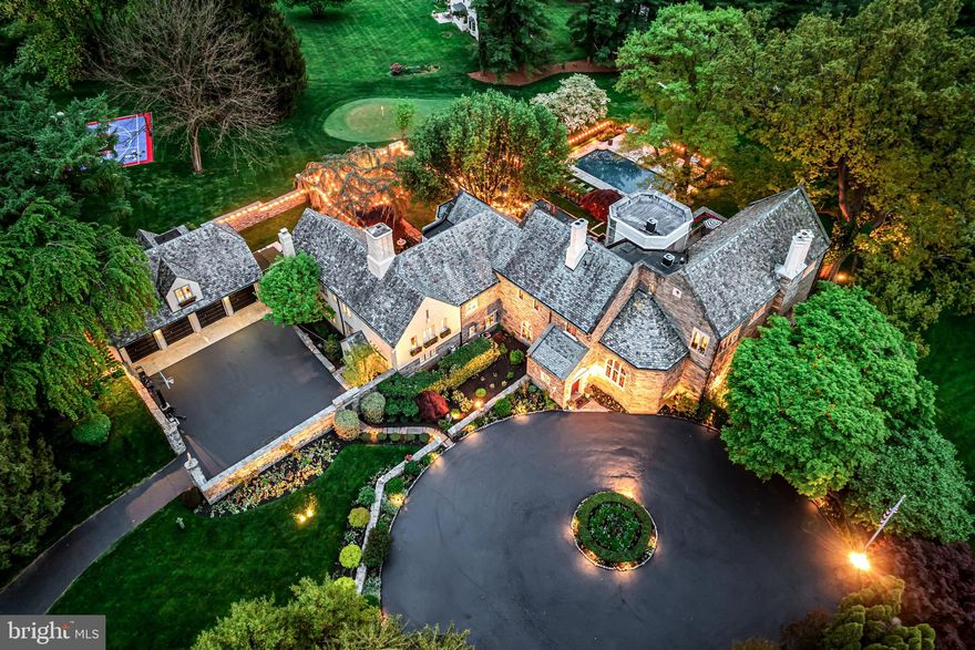 Interior pictures coming next week. Introducing 209 Tower Rd, Villanova, where classic Main Line architecture meets modern amenities. This historic Country Home Estate, nestled on 2.5 acres of meticulously manicured grounds with gardens, courtyards, fountains and a reflecting pond stocked with koi, invites you into a world of timeless elegance and sophistication.
Originally built in 1928 on 100 acres, this solid stone, classic estate home has been thoughtfully updated while preserving its rich heritage. This 8,920 sq ft home features 8 bedrooms, 7 full and 2 half bathrooms, including 5 en-suite bedrooms. Above the 4-car garage is a beautiful 1-bedroom, 1 bathroom apartment with a kitchenette. The upgrades to this home are numerous, but took into account the magical history of the property. The majestic foyer sets the tone, leading you to a Great Room with 22 ft ceilings adorned with wood beams, and a mahogany entry with balcony and library above. A breathtaking 18 ft stone cathedral picture window offers panoramic views of the grounds. Centering the room is a 16th Century Scottish Limestone fireplace. Continue through original carved doors to the covered terrace created as an outdoor living room.
Many of the features of the home include hand-carved entry doors, stained glass windows, imported fireplace surrounds, tunsian tiles, and statuaries were exported from castles in Europe by the original owner and assembled by renowned architects, Walker and Gillette.
The primary suite boasts vaulted ceilings, a working fireplace, an ensuite bath, and two spacious dressing rooms with a sitting room and additional fireplace. Double doors lead to a private terrace overlooking the grounds and the pool. This 2nd story terrace also features gardens with seasonal flowers, a fountain, and the original pulley system for watering. Shade is created by century old specimen trees at each corner. Back inside, ascend the Tower, which was the genesis of the street name, to find a wood-paneled office with unparalleled views, complemented by a full bathroom. Entertainment awaits in the renovated Billiard and Media rooms, complete with coffered ceilings and a custom cabinet built to house 3 televisions for optimal game day viewing. The entire main floor, wine cellar in the lower level, and pool all include a 7 zone HEOS sound system.
The stately and rare slate roof was recently upgraded as were the lead framed windows that adorn the home.
Outside, a walk through the grounds, along the original stone walls, will take you through flowered gardens, past Japanese Maples, Azaleas and unique specimen trees providing a colorful and serene landscape. The property is lined with prodigious Pine Trees that are bedded with their own needles. Follow stone paths to the fountains within the reflecting pond, filled with colorful, swimming Koi fish. A waterfall will lead you to the fountains by the ample pool surrounded by flower gardens with a view of the beautiful Rose bush that covers the back wall of the home.  A putting green with its own sand trap and 2 tees to work on your short game awaits. Additionally you will find a  basketball/pickleball court complete with Sixers logos to honor our hometown team. All add to the outdoor allure.
Located in the prestigious Radnor School District, just 1 mile from Villanova and the train station with service to Philadelphia and NYC, this estate offers the perfect blend of privacy and convenience. With its timeless charm and modern amenities, 209 Tower Rd is more than a home—it's a legacy.