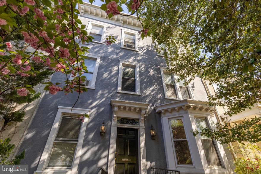 Positioned on the coveted 200 block of East Capitol Street, just steps from the Supreme Court and the grounds of the U.S. Capitol, this exceptional residence offers a rare opportunity to own a piece of Washington’s earliest residential history.  The perfect place to entertain your most important guests with meetings and fundraisers.  With origins believed to date to the pre–Civil War era, the home stands among Capitol Hill’s oldest surviving structures—part of a small collection of early residences that helped shape the neighborhood as it evolved alongside the nation’s capital.
 
Spanning nearly 4,500 square feet, the property offers ten bedrooms and six bathrooms, presenting extraordinary scale and flexibility rarely found in such a premier location. Throughout its history, the home has been owned and occupied by professionals including physicians and government-affiliated residents, reflecting its longstanding connection to the civic and political life of Washington. This legacy, combined with its size and layout, makes it exceptionally well-suited for a variety of uses—whether as a grand private residence, multi-generational living, an investment property, or a thoughtfully reimagined boutique offering.
 
Rich in character, the interiors showcase hardwood floors in excellent condition, two fireplaces, and architectural elements that speak to its historic construction, including substantial masonry, original proportions, and details preserved through generations of adaptation. A distinctive circular staircase leads to the roof, offering the opportunity to create a private outdoor setting with views over one of the city’s most iconic corridors.
 
The rear lot provides a rare parking pad accommodating eight or more vehicles—an invaluable amenity on East Capitol Street. Just beyond the home, the neighborhood unfolds with unparalleled historical and cultural significance. East Capitol Street itself serves as one of Washington’s most prominent and ceremonial avenues, lined with stately residences and anchored by landmarks including the Library of Congress, the Supreme Court, and the U.S. Capitol. For generations, this area has attracted lawmakers, dignitaries, and professionals drawn to its proximity to the center of government and its enduring architectural character.
 
Offering a unique blend of scale, provenance, and location, this property presents more than just a home—it is a living piece of Capitol Hill’s history, ready for its next chapter.