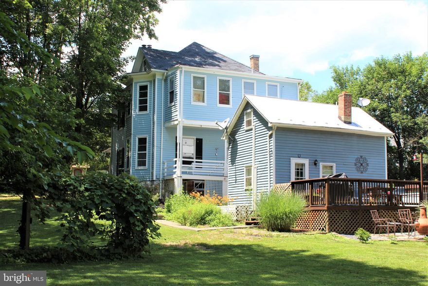 Enjoy small town living with this 3 bedroom 2 bath home in the heart of Woodstock.  Charming with hardwood floors, central A/C, and heated/cooled attic ready to finish for added living space .  Notice details like:  built in cabinet, pocket doors, etc.   It also boosts a cottage which is an established Airbnb rental.  Live in one and rent the other.  Great spacious back yard with a barn for possible garage/workshop with storage.