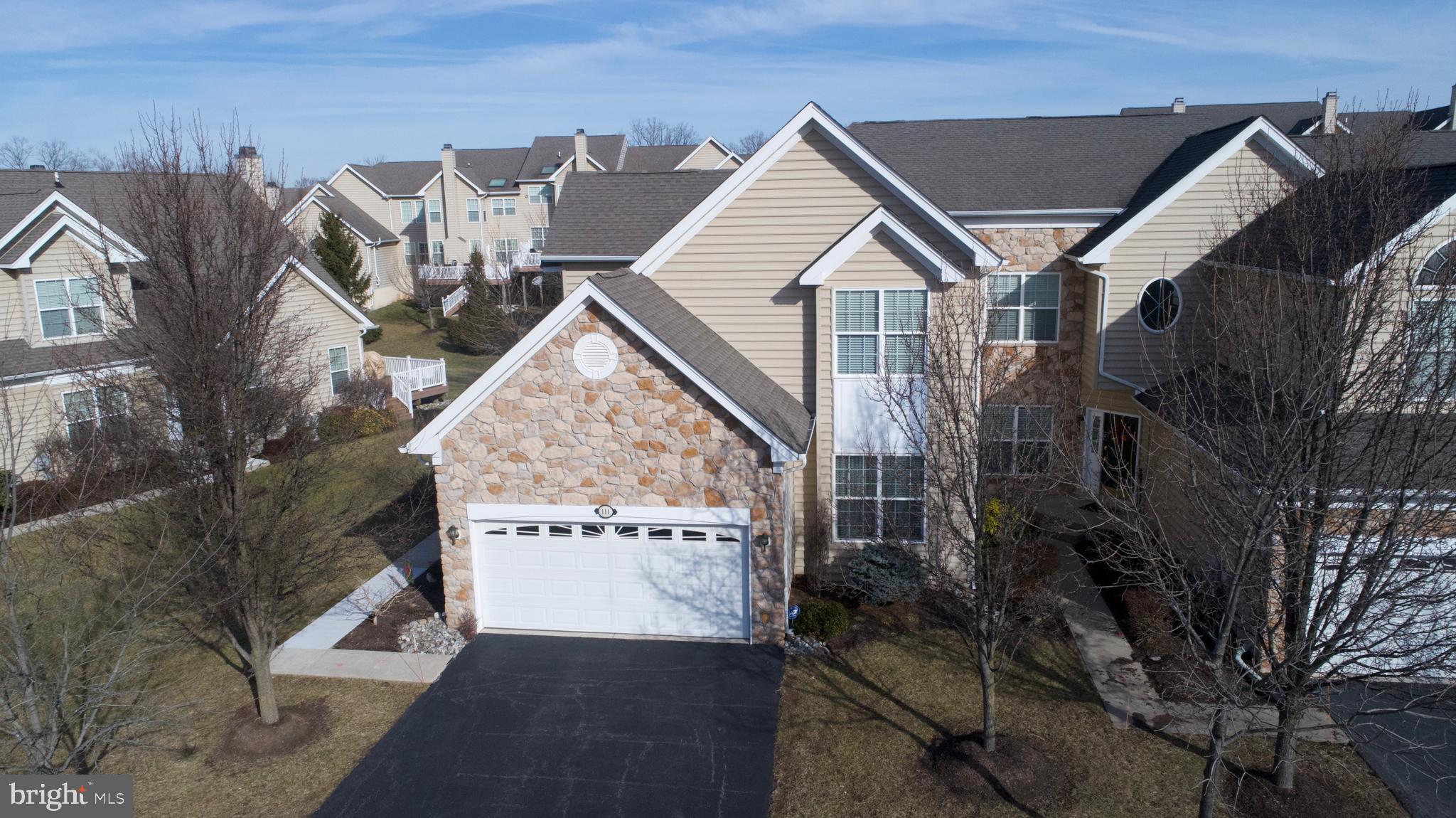 Welcome home to 111 Osprey Way in the exclusive Rivercrest Community. This 3 bedroom, 2.5 bathroom, end unit townhome will delight you with the upgrades and sellers meticulous attention to detail throughout.  Stunning hardwood floors through the entire first floor including first-floor master suite. Entering the home, you will be charmed by the two-story family room/entertaining area with a gas fireplace and decorative columns.  It is truly a warm and cozy feel. Off this space, you will enjoy the abundant natural light of the sunroom which opens onto a spacious deck which enjoys shade most of the day! The master bedroom also faces the rear of the home and has high cathedral ceilings, his and hers walk-in closets with custom built-in shelving and cabinets, and more natural light! The master bath has been upgraded with granite countertops, tiled and oversized shower, jetted soaking tub and tiled flooring. Back in the hub of the home, the dining room with tray ceiling and custom trim work opens onto the kitchen which is just gorgeous! Quartz countertops, tiled backsplash, double wall oven (one is convection), gas stove and upgraded appliances. The pantry area in the kitchen doubles as a laundry room but also has wiring for laundry in the unfinished basement. Upstairs, two nice sized bedrooms with full bathroom plus an additional loft area (easily enclosed for another bedroom or private office space) perfect for kids, entertaining, office or whatever your needs may require. Water softener, security system,  recently upgraded air conditioner and recently professionally re-landscaped. Sellers love the local walking trails that take them straight into Phoenixville if you want to enjoy a leisurely stroll into town.  This community is gated and incredibly safe and offers a clubhouse,  pool... plus did I mention the golf course?  The course is challenging and picturesque. Are you ready for your new way of life? No maintenance living. first-floor master suite..nearby shopping and dining in Providence Towne Center and Phoenixville! Do not miss your opportunity to own this beautiful home.  Don't wait!
