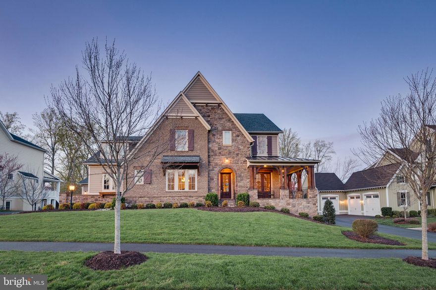 Nestled in the Grove Village of Highly Desired Willowsford, this Exquisite Oakton Model by Drees Homes exemplifies luxury and class!  This meticulously maintained home boasts 4 bedrooms, 3 full and 2 half bathrooms and 6,151 sq ft over 3 levels. A grand hardwood foyer welcomes you with 10 ft ceilings leading into the open floor plan of the kitchen-family room area, which features a fireplace, a breakfast area, and a butler's pantry, creating a perfect flow for entertaining. The chef's kitchen features luxurious floor to ceiling cabinetry, pristine granite counter tops, a massive breakfast bar island, top-of-the-line stainless steel appliances, and a walk-in pantry with custom shelves. Additionally, this level boasts a cozy living room with French doors leading out to the wrap around front porch, a large study with custom built-in shelving and access to the covered rear porch, a formal dining room with updated light fixtures, and a half bathroom. Upstairs, the primary suite offers a sitting area, dual walk-in closets, and a luxurious spa-like bath with a glass enclosed shower and separate free-standing soaking tub. Three more spacious bedrooms each come with large walk-in closets. Spend night entertaining guests in the fully finished expansive walk-out lower level.  The basement area boasts a recreation room with custom board and batten accent walls, a full bar with a wine fridge, modern cabinetry and granite counter tops – perfect for hosting on game days. This level also features a half bathroom, two massive storage spaces, and direct walk-out to the stone patio in the rear of the home. Beyond the stunning interior, this expansive property includes a pristine outdoor space. Enjoy the patio or unwind on the covered rear porch which features view of a forest and privacy in the backyard.   Close Willowsford amenities include walking distance to the Zip Line Park, the Trailhead Pavillion Area, The Lodge Pool and Fitness Center, Willowsford Lake Boathouse, and miles of hiking trails.  These are just a few features of what this amazing community has to offer.  Located in Aldie, this property falls within the top-rated Lightridge High School pyramid.  Don't Miss this Incredible Opportunity!