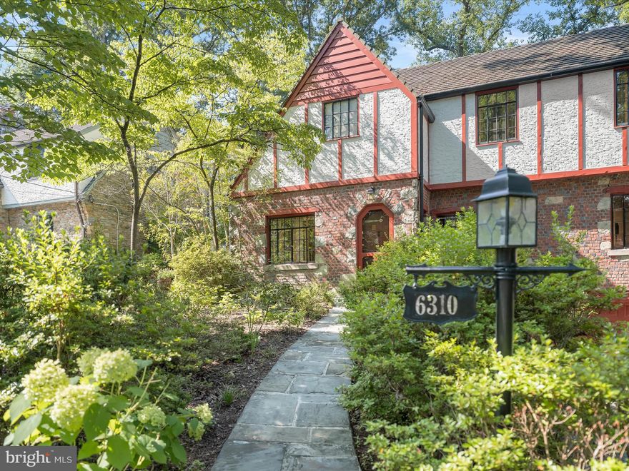 $15K buyer credit for contract ratified by Monday! OPEN SUNDAY, AUG 10, 2-4 PM! Welcome to this charming 1930s Tudor nestled in Bethesda’s idyllic Woodhaven neighborhood. Surrounded by mature landscaping and vibrant azaleas, this storybook home blends timeless character with thoughtful modern updates. Step inside to enjoy sightlines to the lush wooded yard through the inviting living room with exposed wood beams, a cozy window seat, and a gas fireplace framed by a stone mantle. An elegant and spacious formal dining room leads to the heart of the home - a beautifully renovated and expanded kitchen and family room. The stunning and recently renovated kitchen features a 48” Wolf range, farmhouse sink, beverage fridge, spice cabinet, and custom pantry with rollouts, and opens to a sun-drenched family room expansion with floor-to-ceiling windows, exposed brick, and a dramatic stone mantle with a wood-burning stove. Beautiful hardwood floors, a charming entryway, and a convenient powder room complete this picturesque main floor. Hardwood floors extend to the upper level, where you’ll find four spacious bedrooms. The primary suite offers a spa-like renovated bathroom featuring a handmade dual vanity, copper sinks, and a walk-in spa shower as well as a walk-in cedar-lined closet. A secondary expanded bedroom features vaulted ceilings with skylights and built-in storage and desks, ideal for a guest suite or spacious home office. Two additional sun-filled bedrooms with spacious closets, as well as an updated hall bathroom, round out the perfectly-sized second level. Downstairs, the finished basement includes a large recreation room with a third stone fireplace with gas insert, as well as a built-in bar and shelving. A spacious laundry area with a utility sink, storage pantry, and a shop room with a woodworking bench provides additional functionality. Two separate doors provide access to the oversized one-car garage and spacious driveway. The backyard features a tranquil paradise with multi-level stone patios, great for entertaining or enjoying peaceful mornings and evenings at home. The fully-fenced yard offers a variety of mature plantings and trees to provide shade, allowing the yard to be enjoyed year-round. Additional features of the home include custom double-pane and Pella windows, updated dual-zone HVAC, a new water heater, and so much more! This exceptional property offers the best of old-world charm and modern living in one of Bethesda’s most cherished neighborhoods. Just minutes from downtown Bethesda, multiple public and private schools, public transportation, I-495, and so much more, you don’t want to miss this opportunity to enjoy the tranquility and history of Woodhaven!