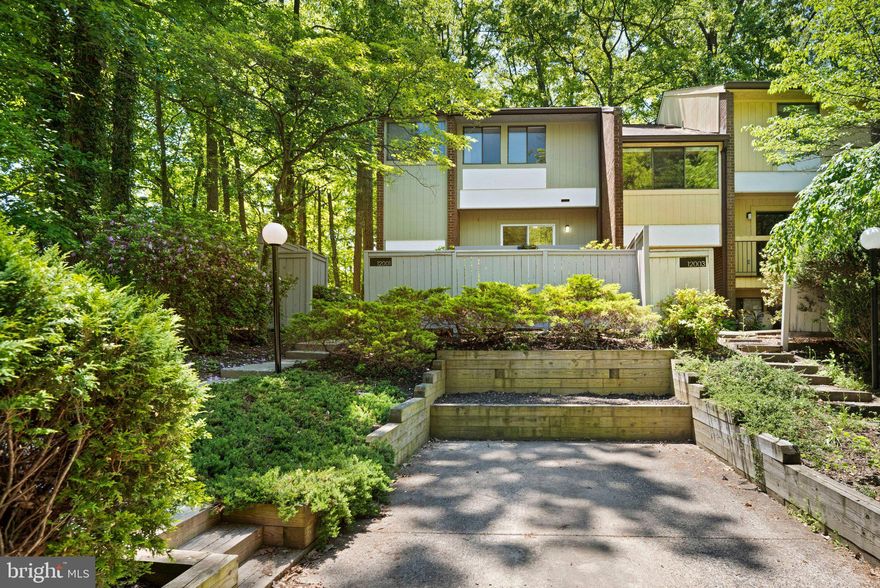 Tucked on a quiet cul-de-sac in sought-after Reston, this stylish mid-century modern townhome delivers the perfect mix of design, space, and location.

A bright, open layout is filled with natural light and more all throughout. The sunken living room features a cozy fireplace and opens to a private deck—ideal for indoor-outdoor living. The standout gourmet kitchen impresses with quartz countertops, stainless steel appliances, abundant cabinetry, and a spacious eat-in area, plus direct access to a balcony for morning coffee or evening unwinding.

Upstairs, the primary suite offers plush new carpet, two double closets, and a flexible sitting area—perfect for a home office or easily convertible into a walk-in closet. Additional bedrooms provide versatility for guests or work-from-home needs.

The finished lower level expands your living space with endless possibilities—rec room, gym, or media lounge—along with a large utility/storage room and bonus storage under the stairs.

Enjoy multiple outdoor spaces including front and rear patios, plus a private setting with mature landscaping. Parking is effortless with assigned and driveway spaces, plus ample guest parking.

Unbeatable location just minutes (approx. 2 miles) to Wiehle Metro and Reston Town Center, with easy access to shopping, dining, commuter routes, and Reston’s extensive trail system and amenities.

The neighborhood features access to Reston’s extensive network of trails, connecting you to lakes, parks, schools and community amenities throughout the area, including nearby golf and nature centers. When you own this lovely home, you can enjoy all the benefits of the Reston Association, including access to 15 pools, 50+ tennis and pickleball courts, and over 55 miles of scenic trails. The Association is dedicated to preserving Reston’s natural beauty while offering a vibrant lifestyle with year-round events, recreational programs, and community engagement opportunities. Experience the unique Reston lifestyle—where nature, community, and convenience come together in one exceptional place to call home.
Community fees: Reston Association $890/year; Machaan Cluster $550/quarter.